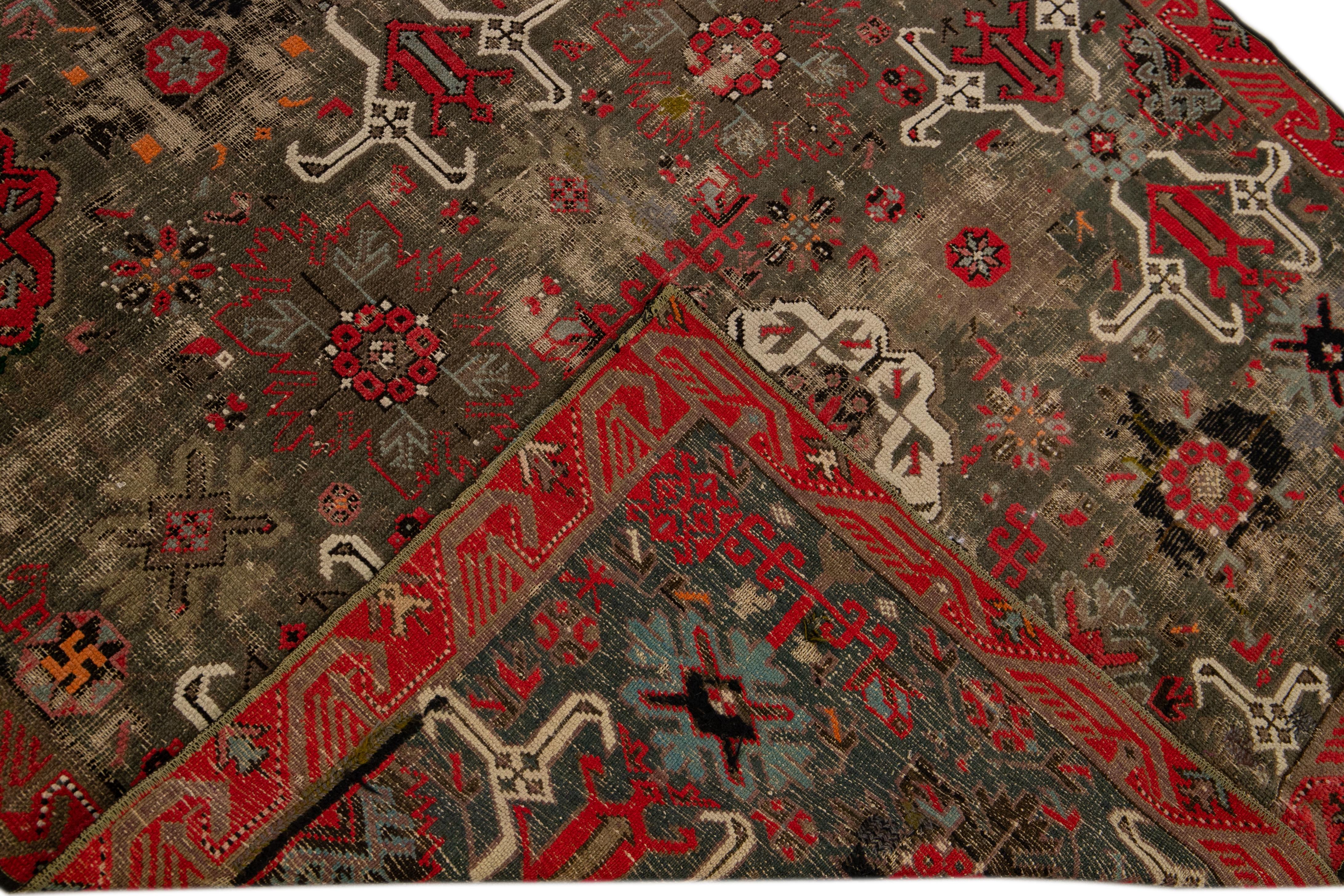 Beautiful antique Malayer hand-knotted wool rug with a brown field. This Malayer rug has an orange, red, beige, and blue accent in an all-over gorgeous floral pattern design.

This rug measures: 4'4