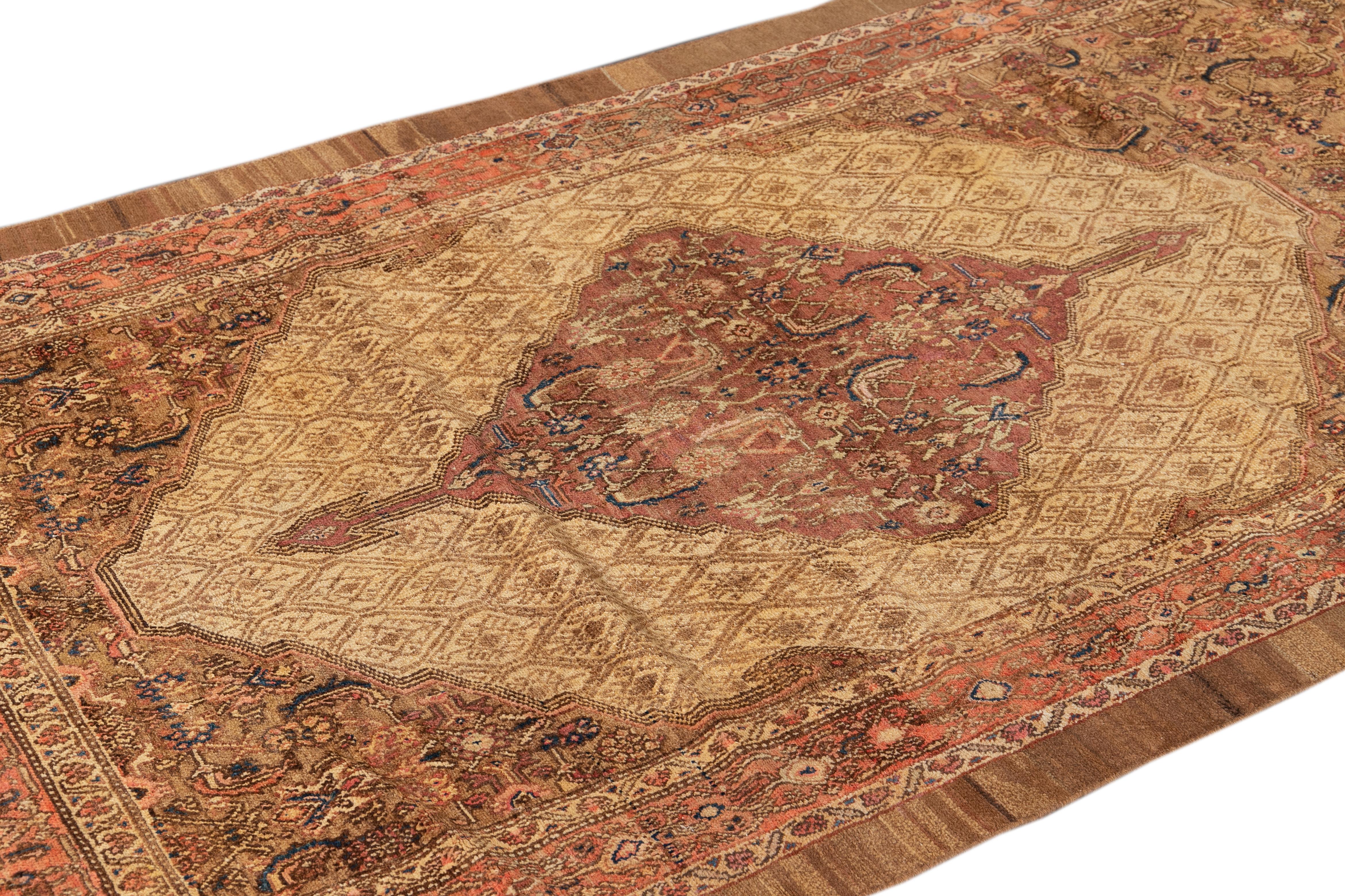 Beautiful 20th-century Malayer hand-knotted long wool runner with a tan field. This Antique piece has brown and rust accents in a gorgeous all-over medallion design.

This rug measures: 3'10