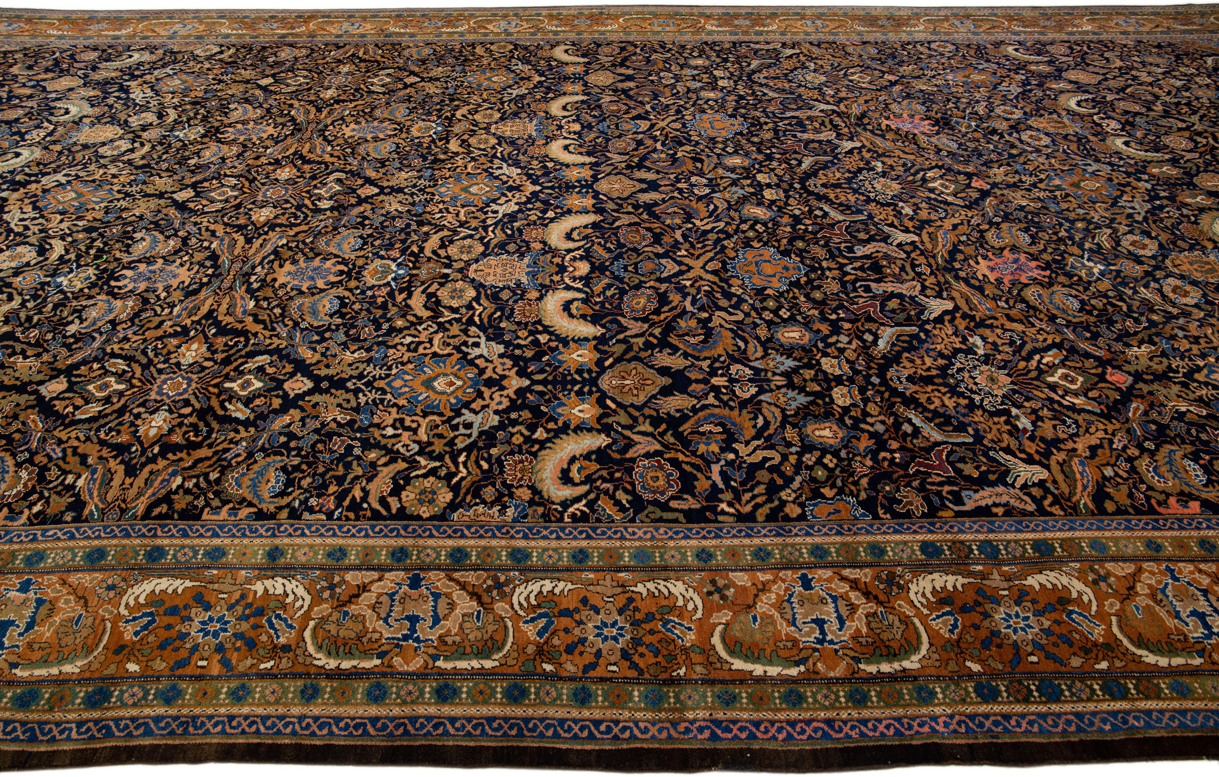 Antique Malayer Handmade Persian Navy Blue Oversize Wool Rug with Floral Motif In Good Condition For Sale In Norwalk, CT