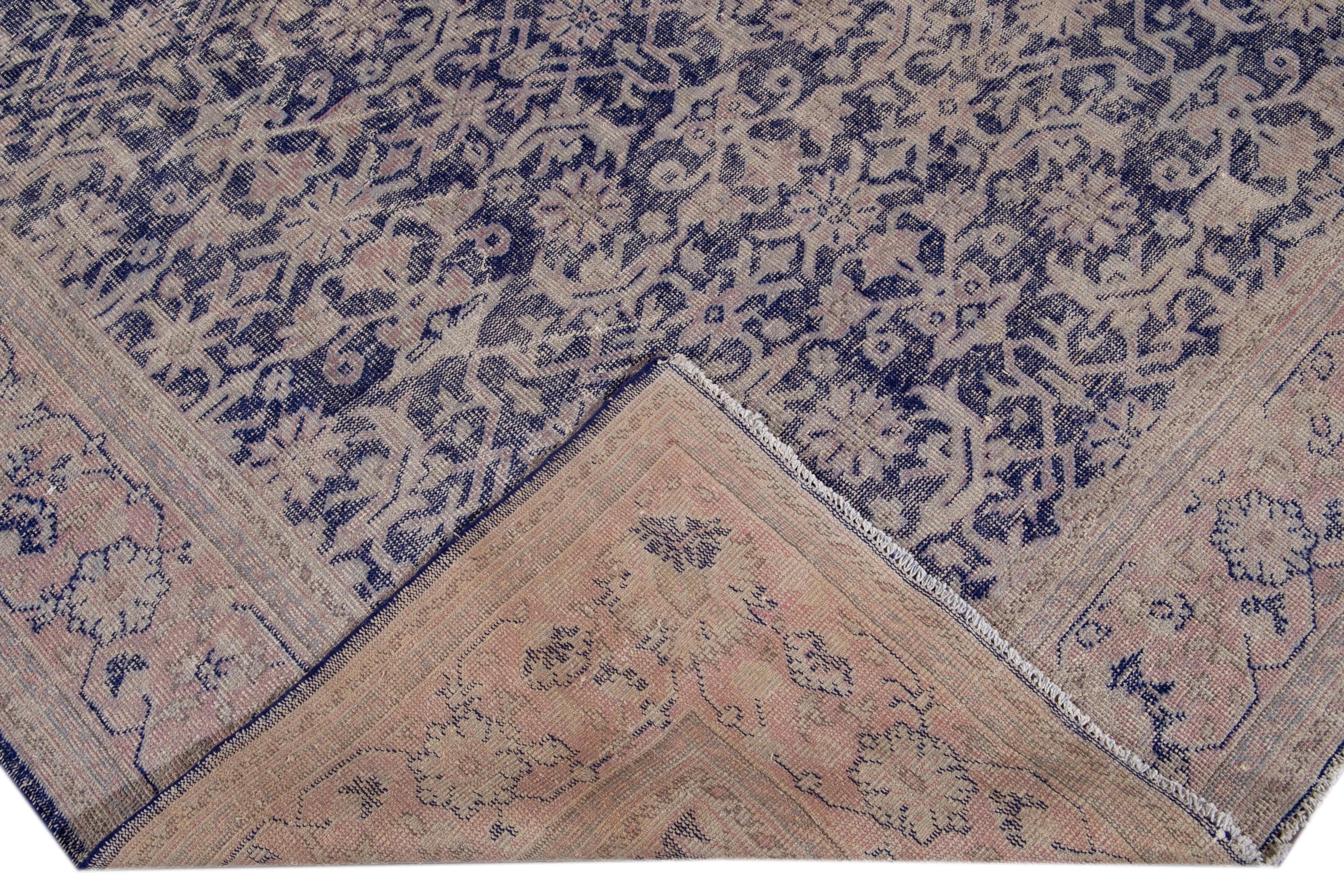 Beautiful antique Malayer hand knotted wool rug with a purple field. This Malayer piece has a pink and beige frame and accents in a gorgeous all-over floral shabby chic design.

This rug measures: 7'3