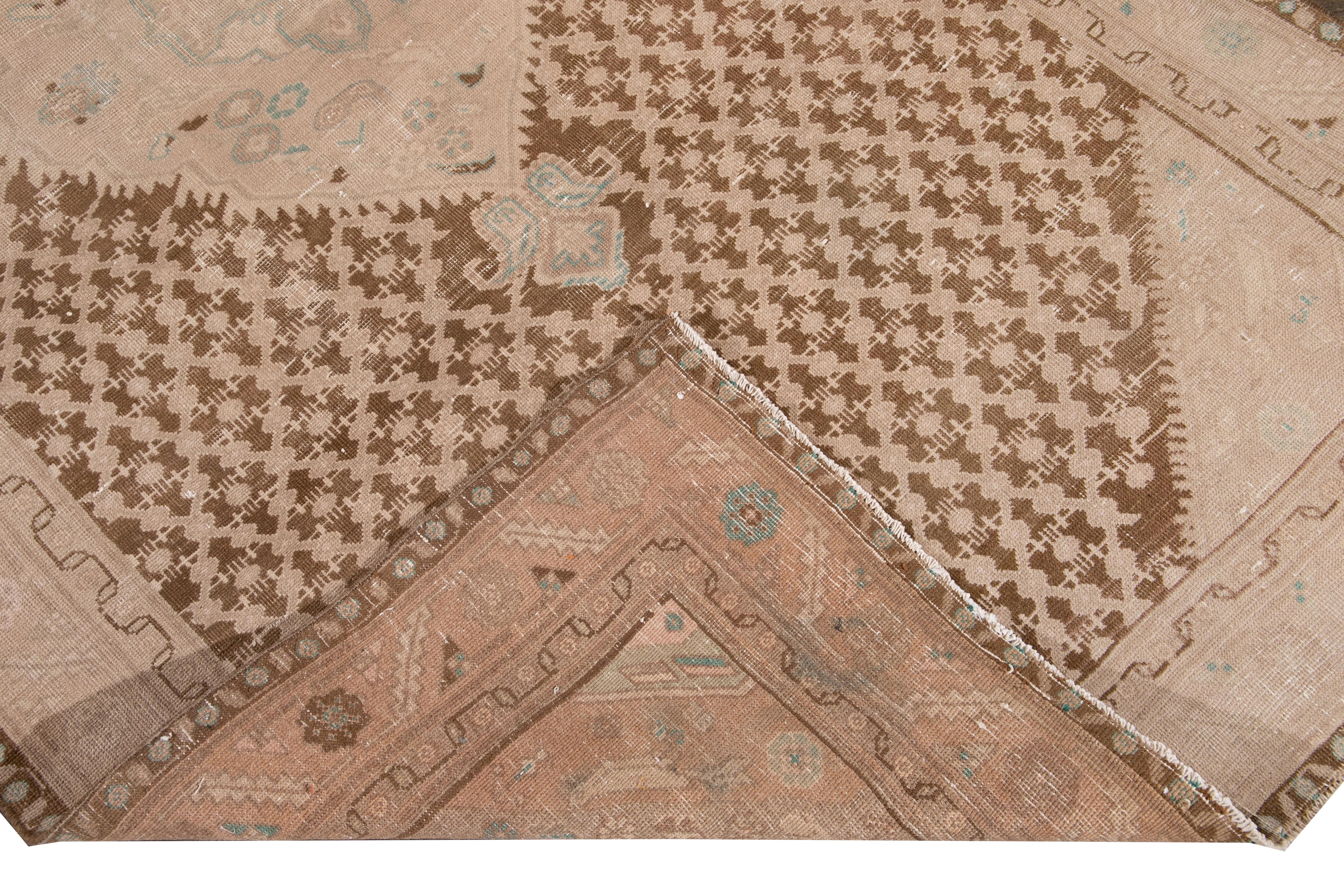 Beautiful antique Malayer Distressed hand knotted wool runner with a brown field. This Malayer rug has accents of peach and blue in an all-over gorgeous geometric medallion floral design.

This rug measures: 5' x 10'.

Our Rugs are professional