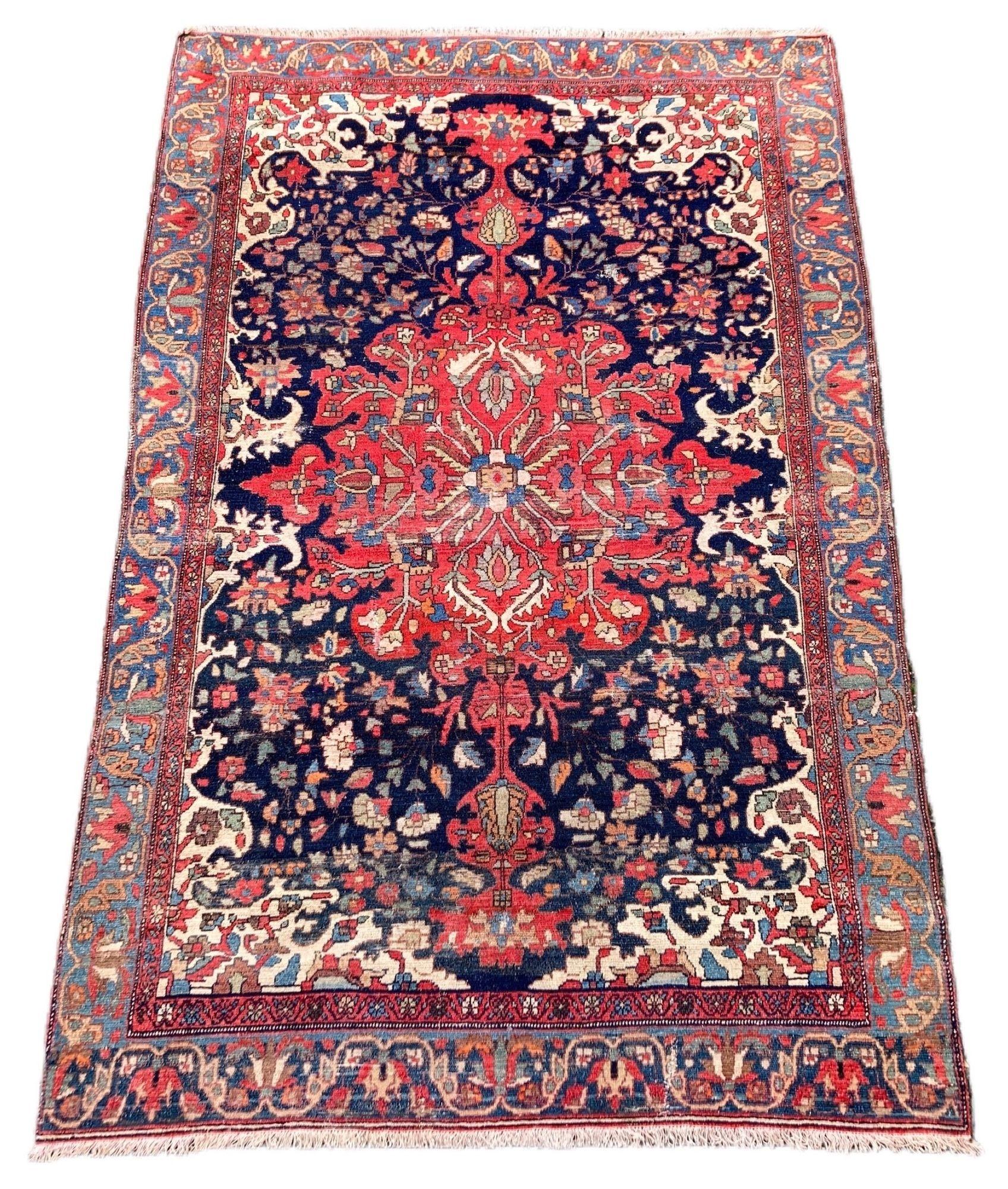A beautiful antique Malayer rug, hand woven in west Persia circa 1900 with a large tomato red medallion on an indigo field and lighter blue border. It may have lost its outer border somewhere on its journey but retains all of its rustic charm.
Size: