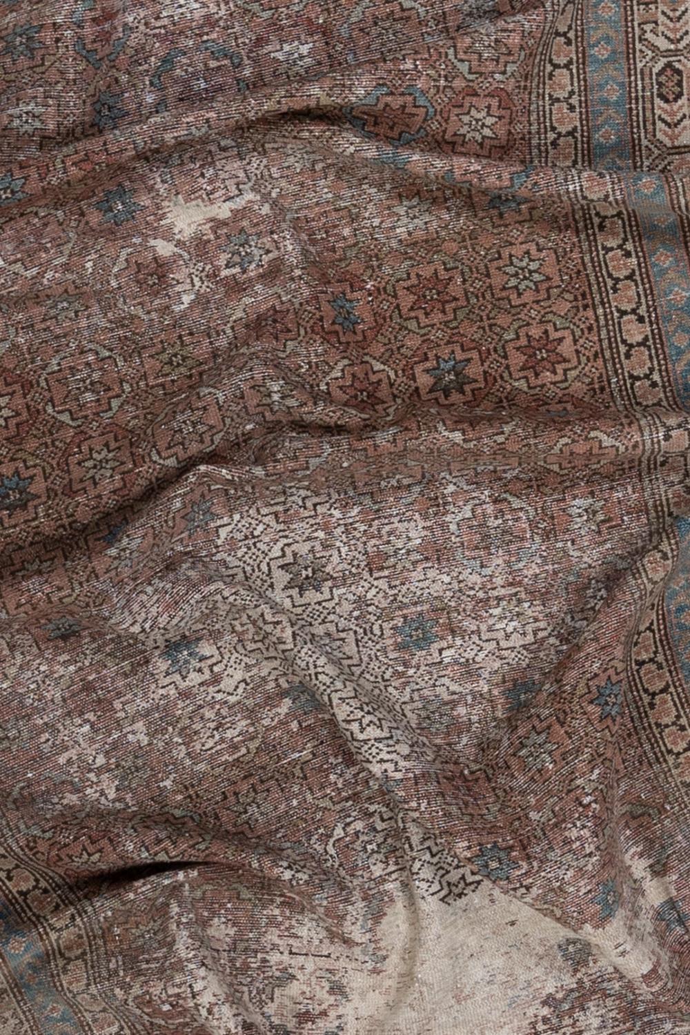 Age: Circa 1920

Colors: mauve, faded dusty rose, olive, blue, dark brown 

Pile: low

Wear Notes: 8 (wear has been reinforced and patching is secure. It is left this way for aesthetics.)

Material: wool on cotton 

Early 20th century Malayer rug