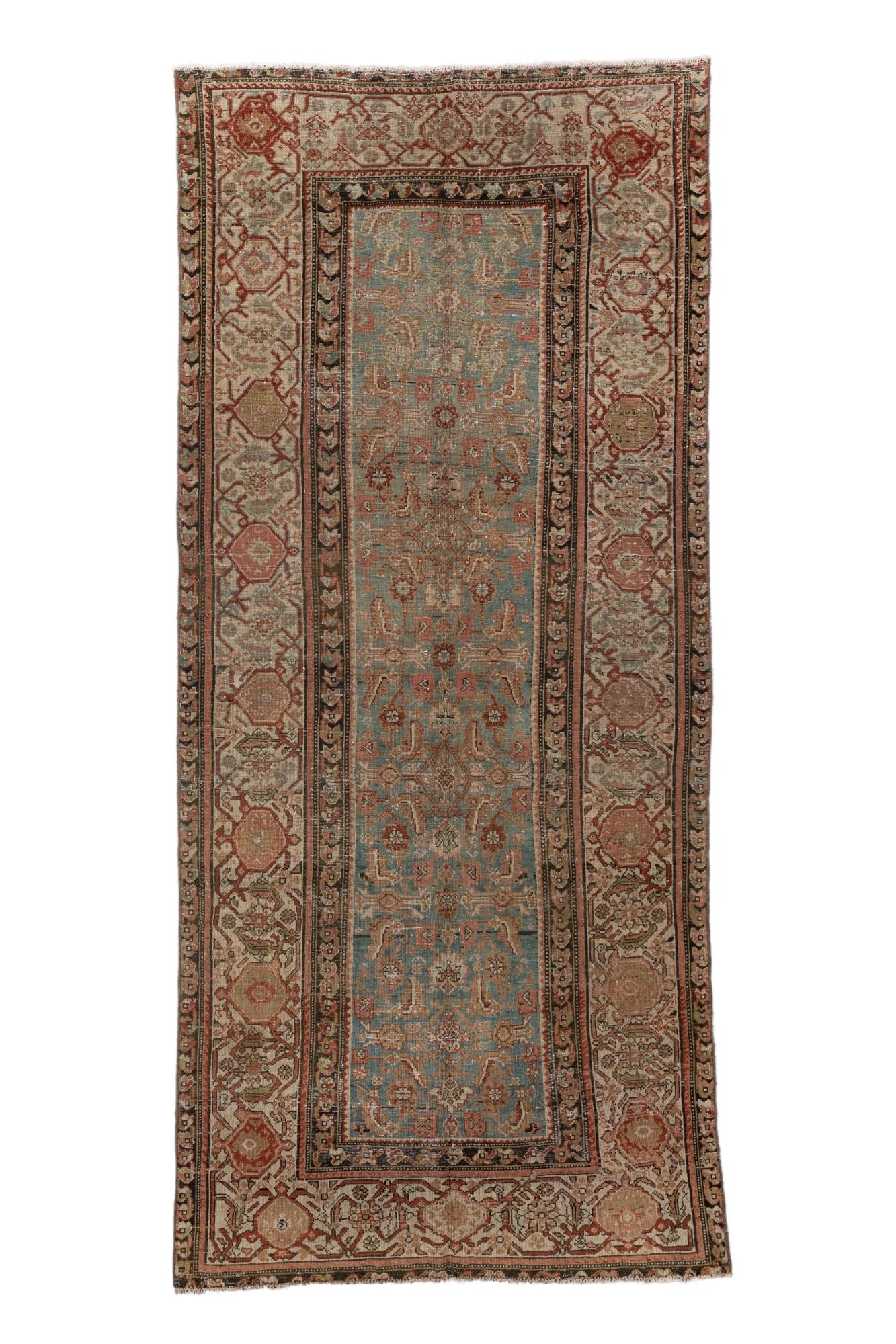 A striking antique Malayer rug hand-knotted in Western Iran, featuring an elongated format with a beautiful interplay of soft blues, rich terracotta, and muted ivory tones. The narrow field is filled with a complex lattice of stylized floral and