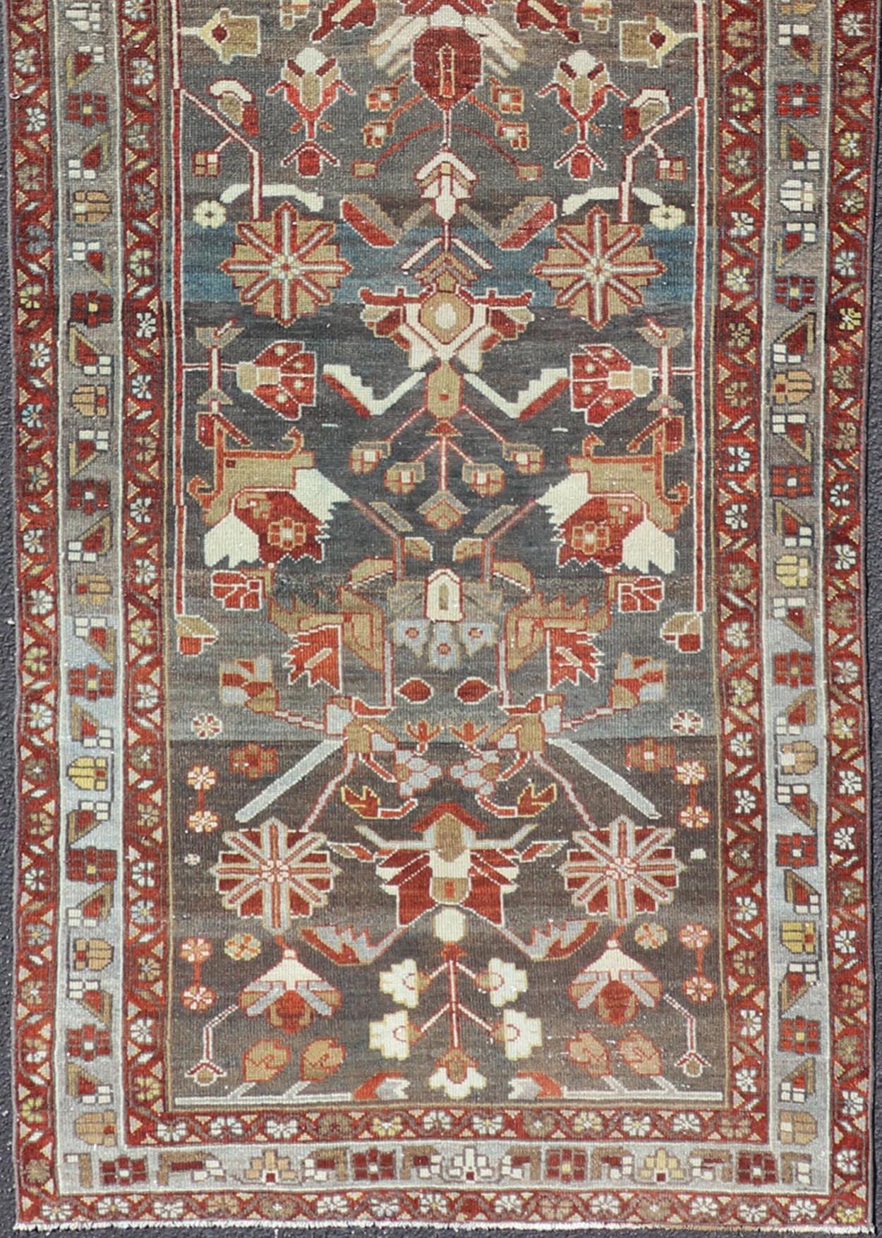 Geometric medallion design Persian Malayer runner with charcoal, gray, blue, red and tan colors, Keivan Woven Arts / rug EMB-9715-P13896, country of origin / type: Iran / Malayer, circa 1920

Measures: 3'6 x 11'10.