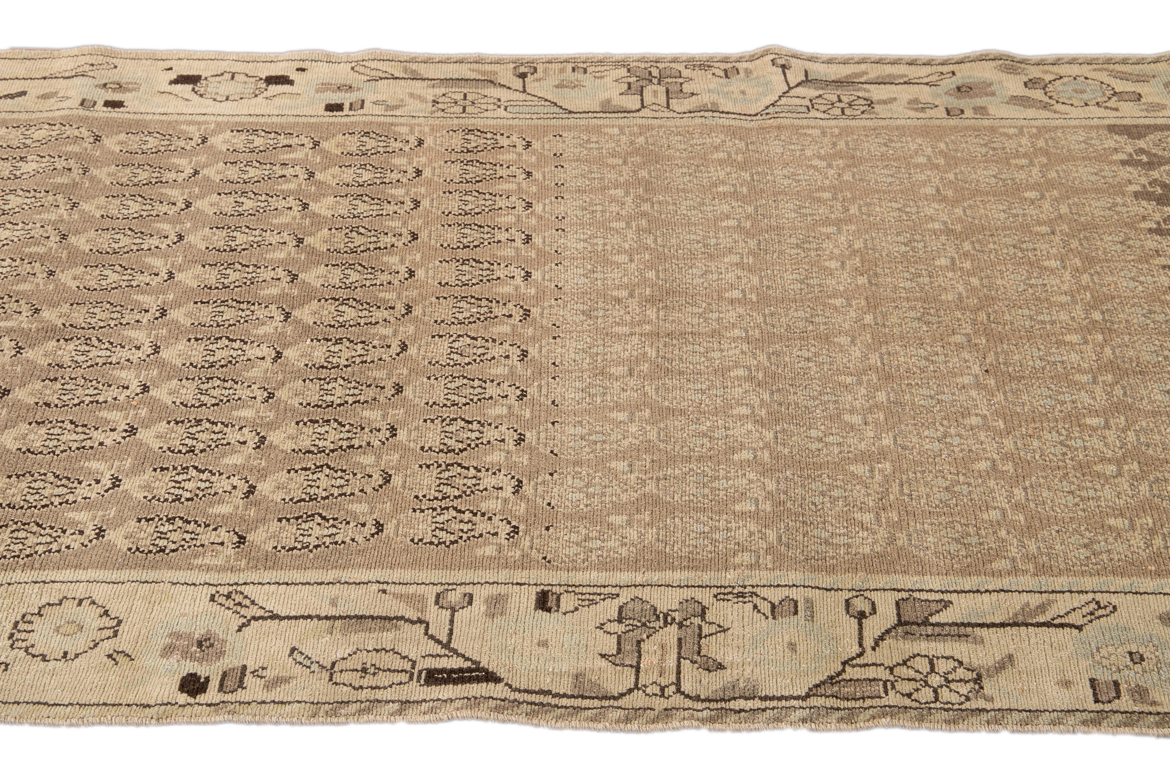 Beautiful antique Malayer hand-knotted wool runner with a Tan field. This Malayer rug has a beige frame and accents of blue and brown in an all-over gorgeous geometric medallion floral pattern design.

This rug measures: 3'7