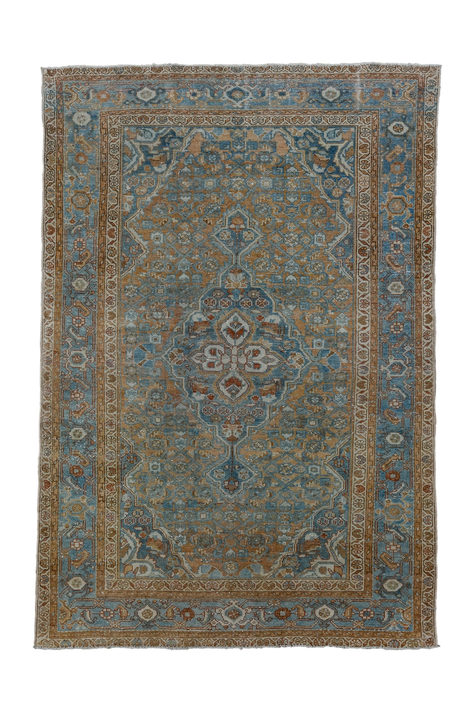 In a classic Persian medallion style and popular palette, this urban/village scatter features  a red-rust  field in a loosely rendered Herati design, with a blue medallion and pendanted blue corners. Strip style light blue main border with reversing