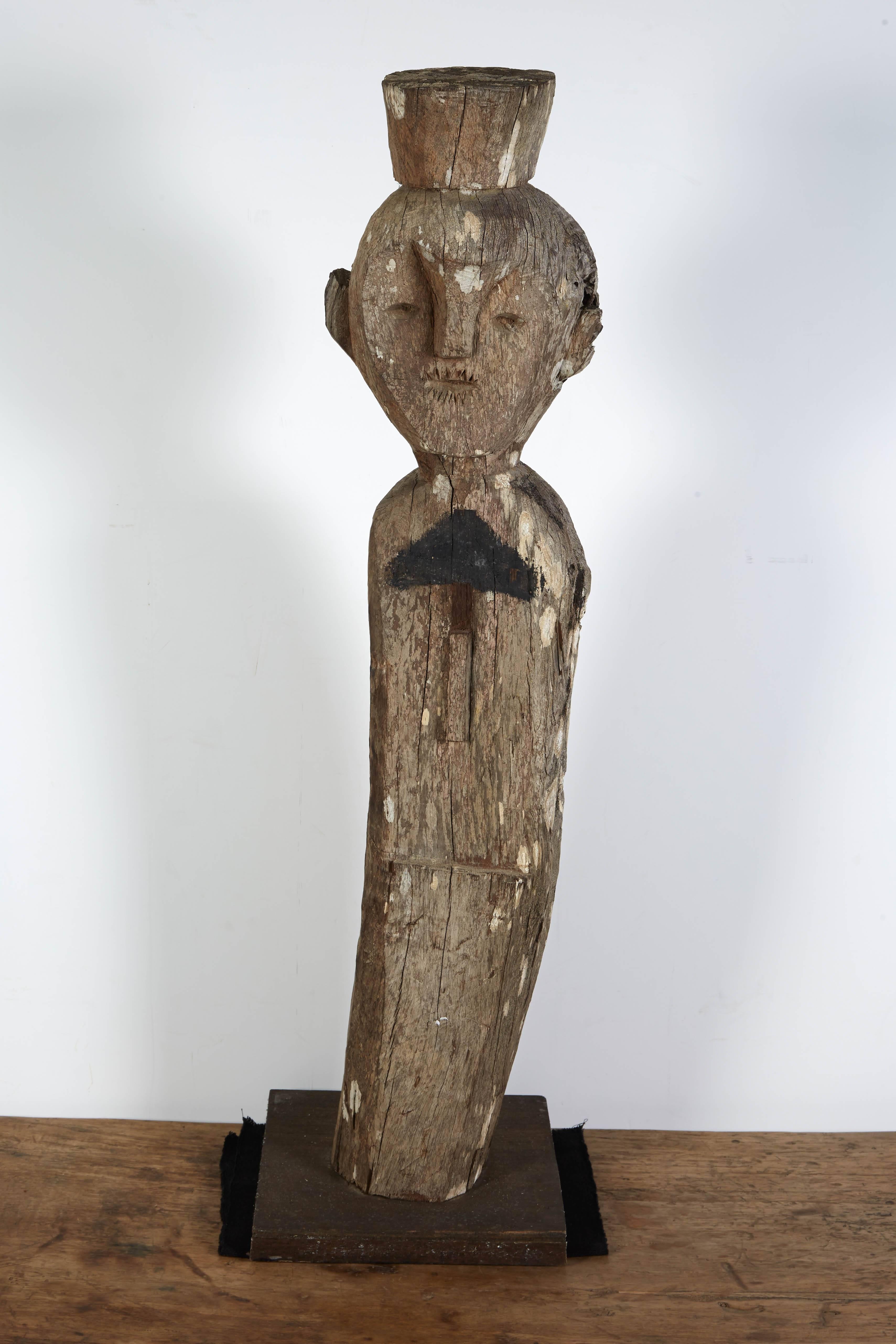 A tall, strikingly carved antique Malaysian guardian figure with traces of old paint and markings. Mounted on custom stand. Sarawak, Malaysia, circa 1900.

BH1014.
