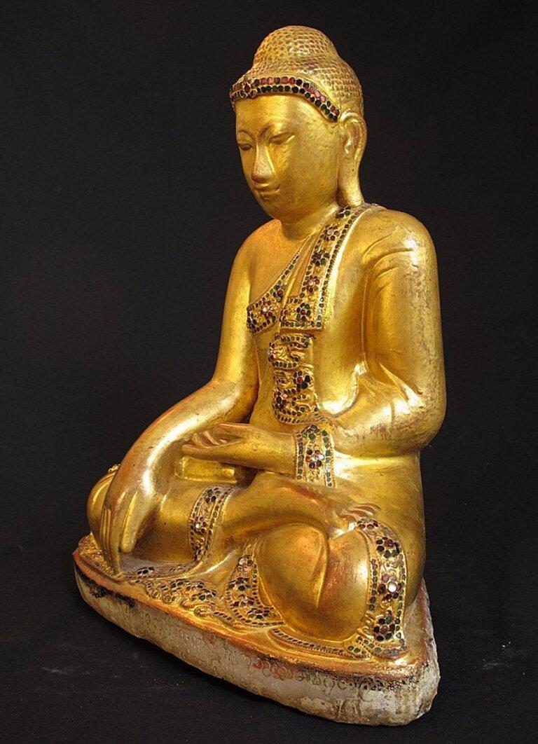 Material: marble
50 cm high 
42 cm wide
Weight: 31.5 kgs
Mandalay style
Bhumisparsha mudra
Originating from Burma
19th century
With Burmese inscriptions
Goldplated with 24 krt. gold.
 