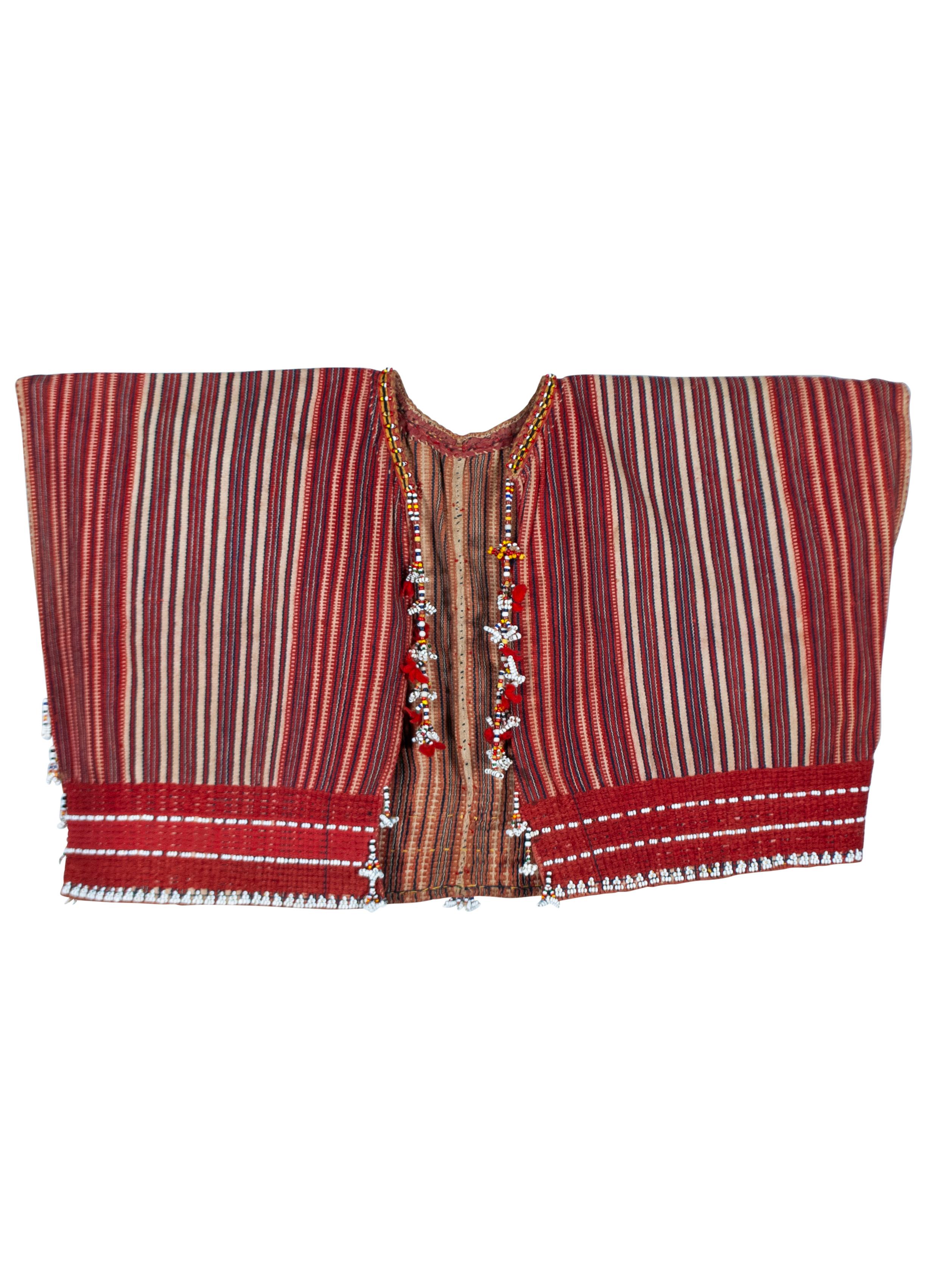 Antique Man’s Ceremonial Beaded Vest (Kuton), Gadding, Philippines

This Gaddang man’s ceremonial vest is from the Cordillera region in northern Luzon, Philippines. It’s composed of tightly woven cotton patterned in a dense composition of vertical
