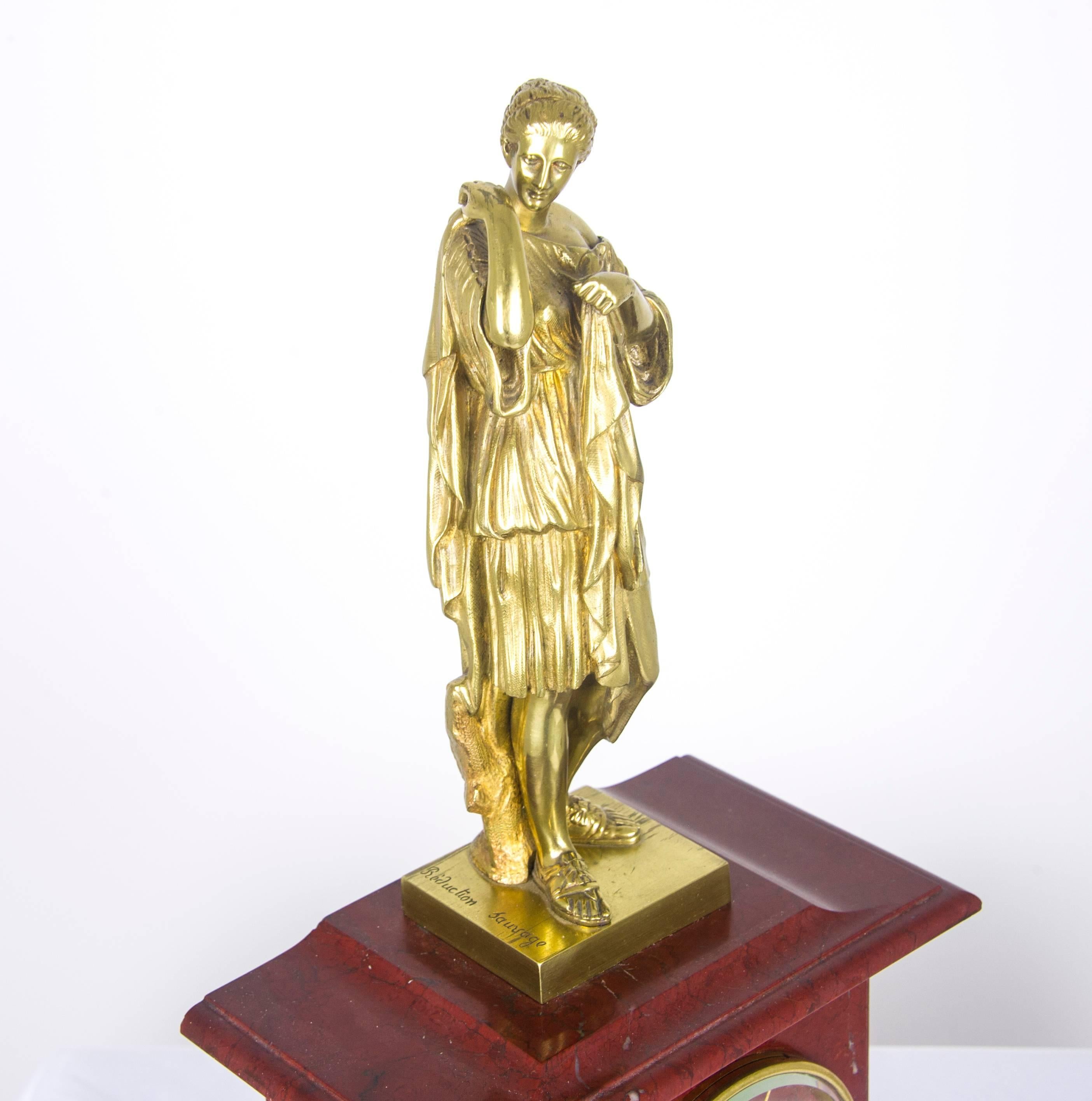 Antique mantel clock, French rouge marble clock, gilt bronze mantel clock, antiques furniture.

France, 19th century.
8 day striking marble French movement strikes on the half and full hour
Fine gilt bronze figure of a Grecian girl on top
Gilt