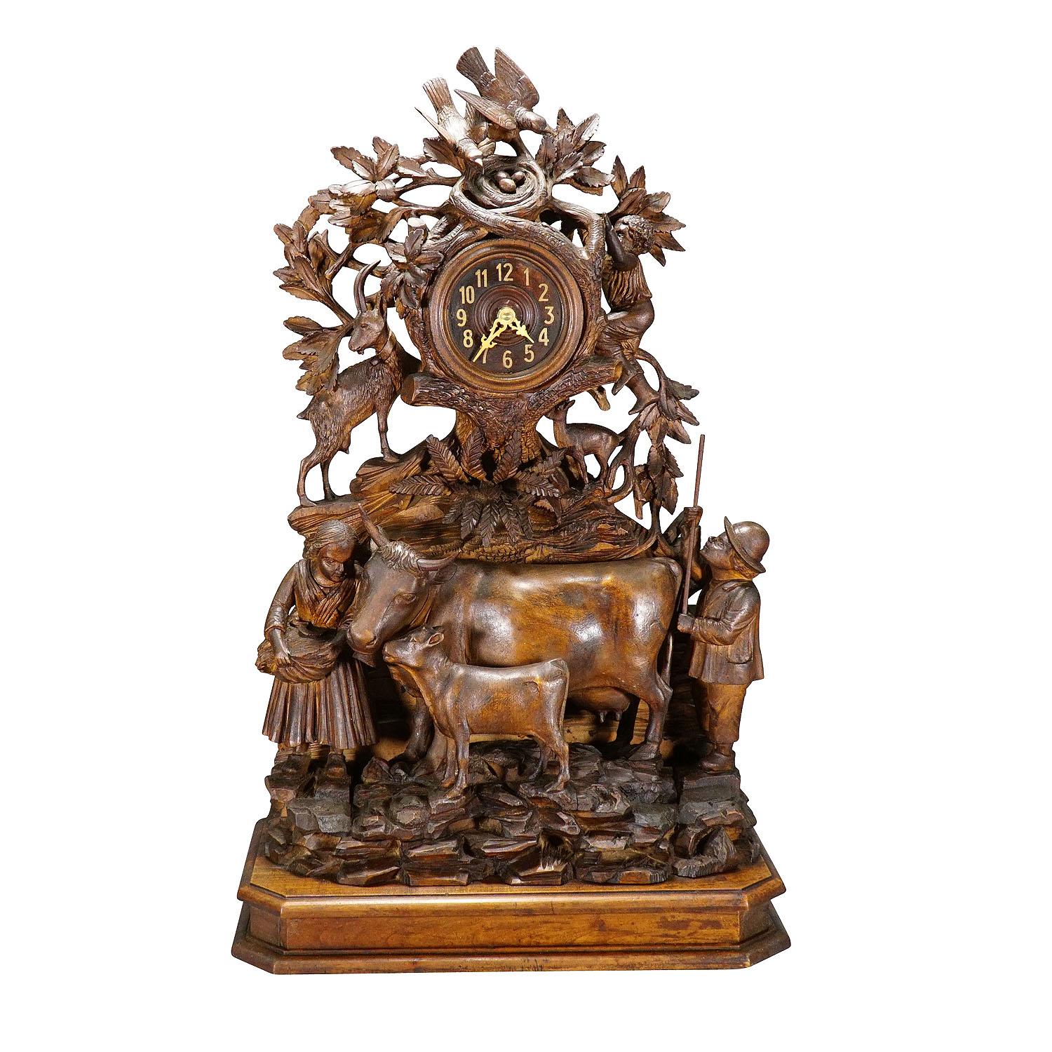 Antique Mantel Clock with Herdsman Family, Goats and Cattle

A Black Forest wooden carved mantel clock with a lovely herdsman family with their goats and cattles. A masterpiece of woodcarving which brightens up any chimney piece. The clockwork is
