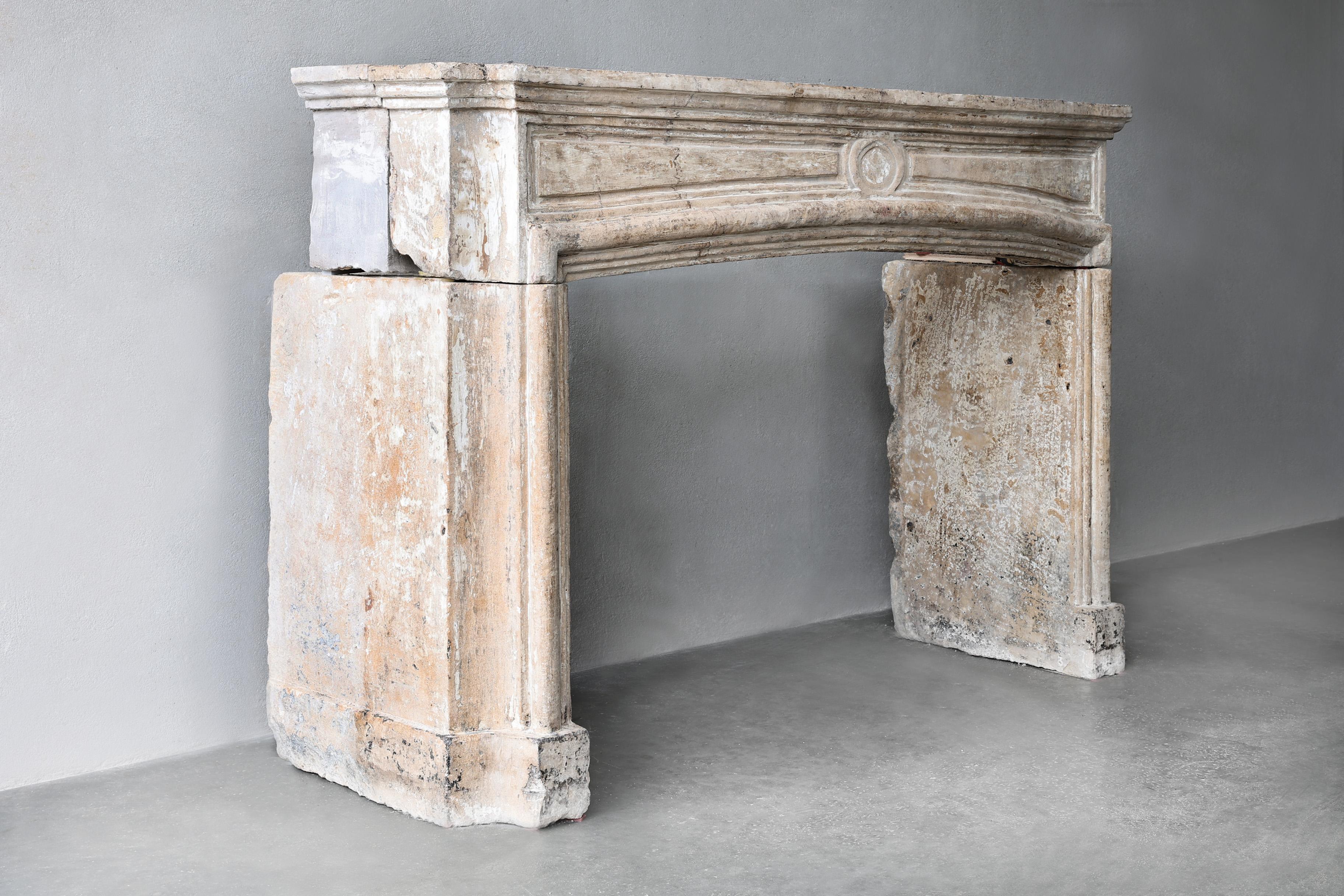 Beautiful unique mantelpiece of French limestone from the 19th century in the style of Louis XIV. A mantelpiece with allure and charisma due to the warm colour scheme, beautiful lines and ornaments. An antique mantelpiece is always an added value