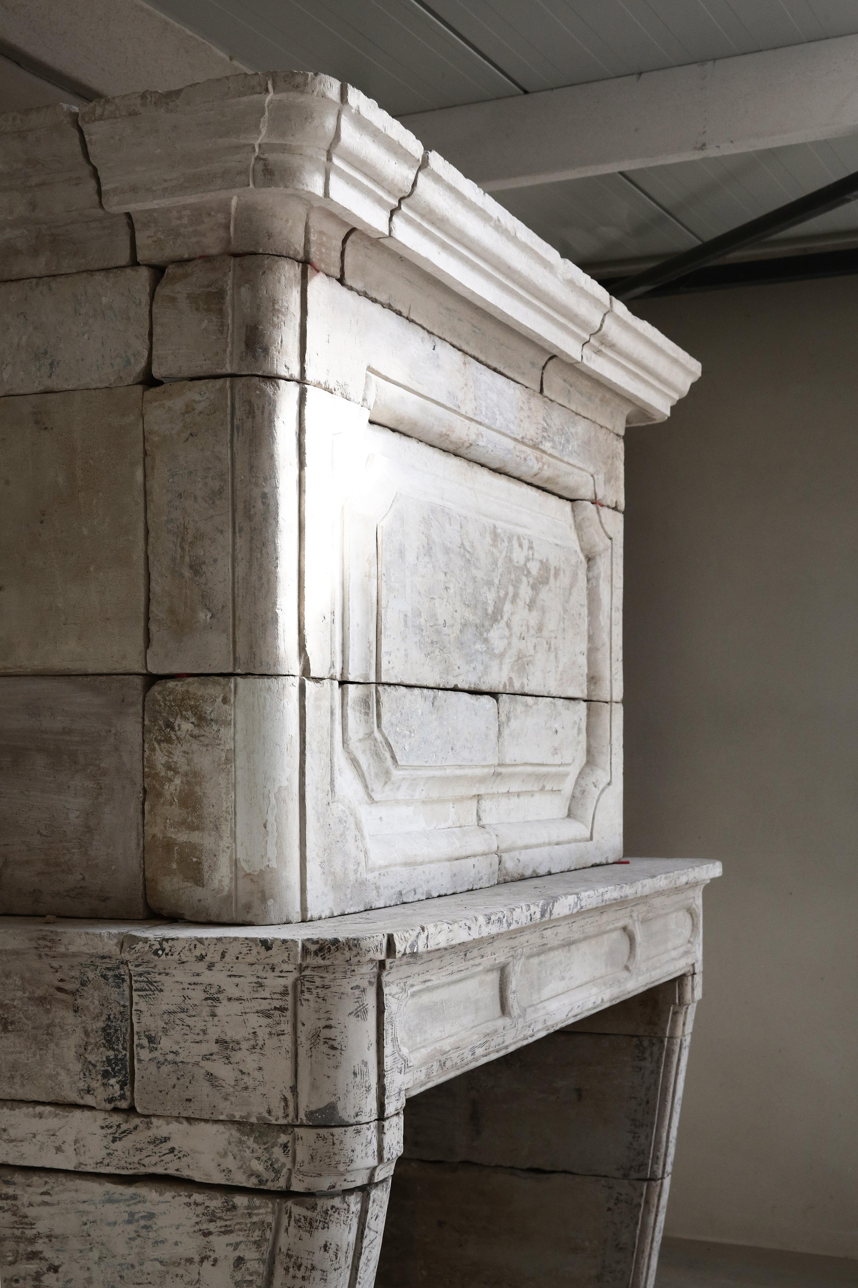 Beautiful antique castle fireplace with trumeau from the 18th century! This fireplace is unique in its kind and special because of the trumeau. The fireplace is made of French limestone and is in the style of Louis XIV. The patinee and shape give