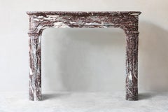 Antique mantel surround of Griotte de Campan rouge marble, style Louis XIV