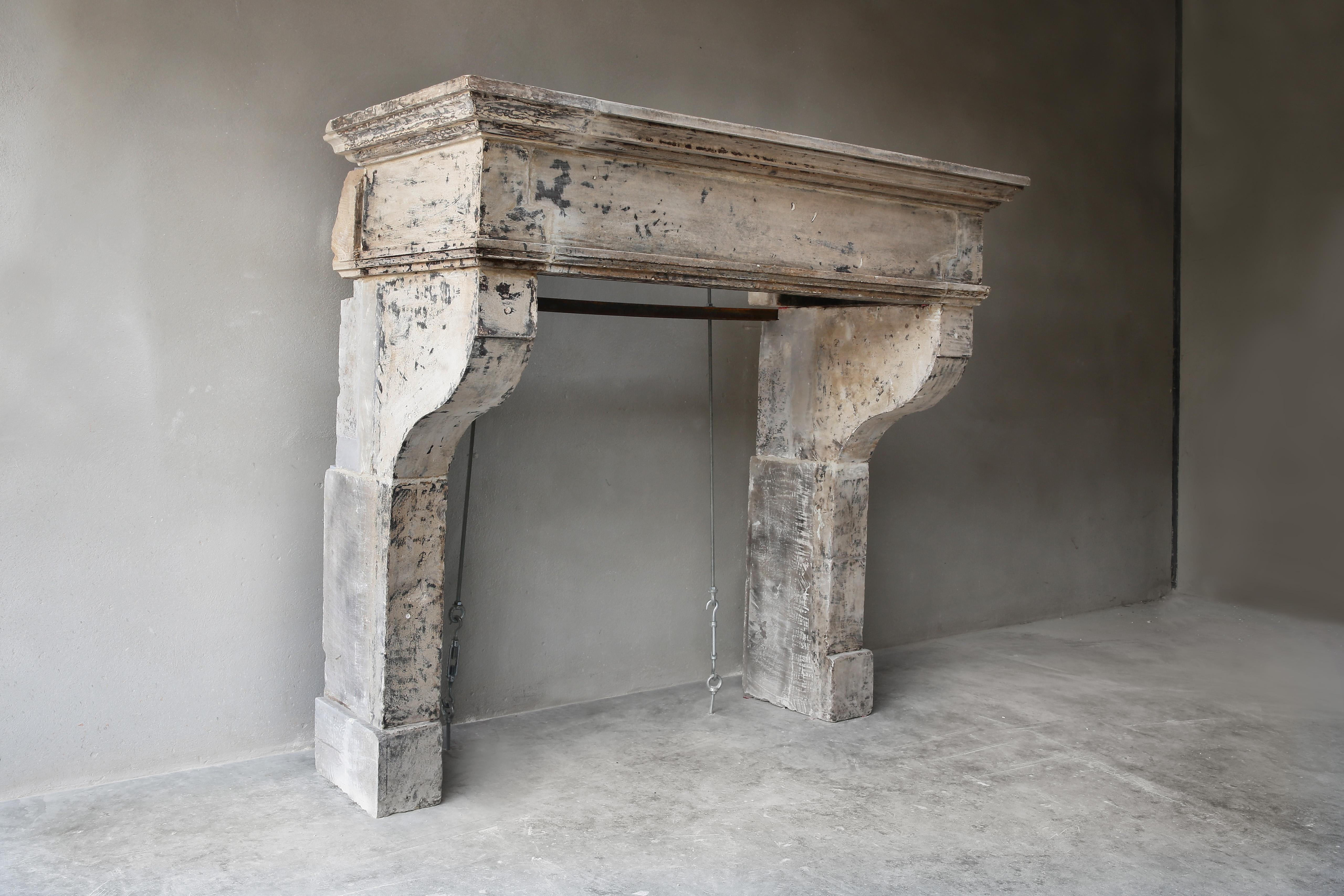 Tough antique chimney from the 19th century of French limestone. This old mantelpiece has a warm color nuance and patine and the moulure (frame) in this fireplace creates an authentic look. A beautiful fireplace that would fit very well in a country