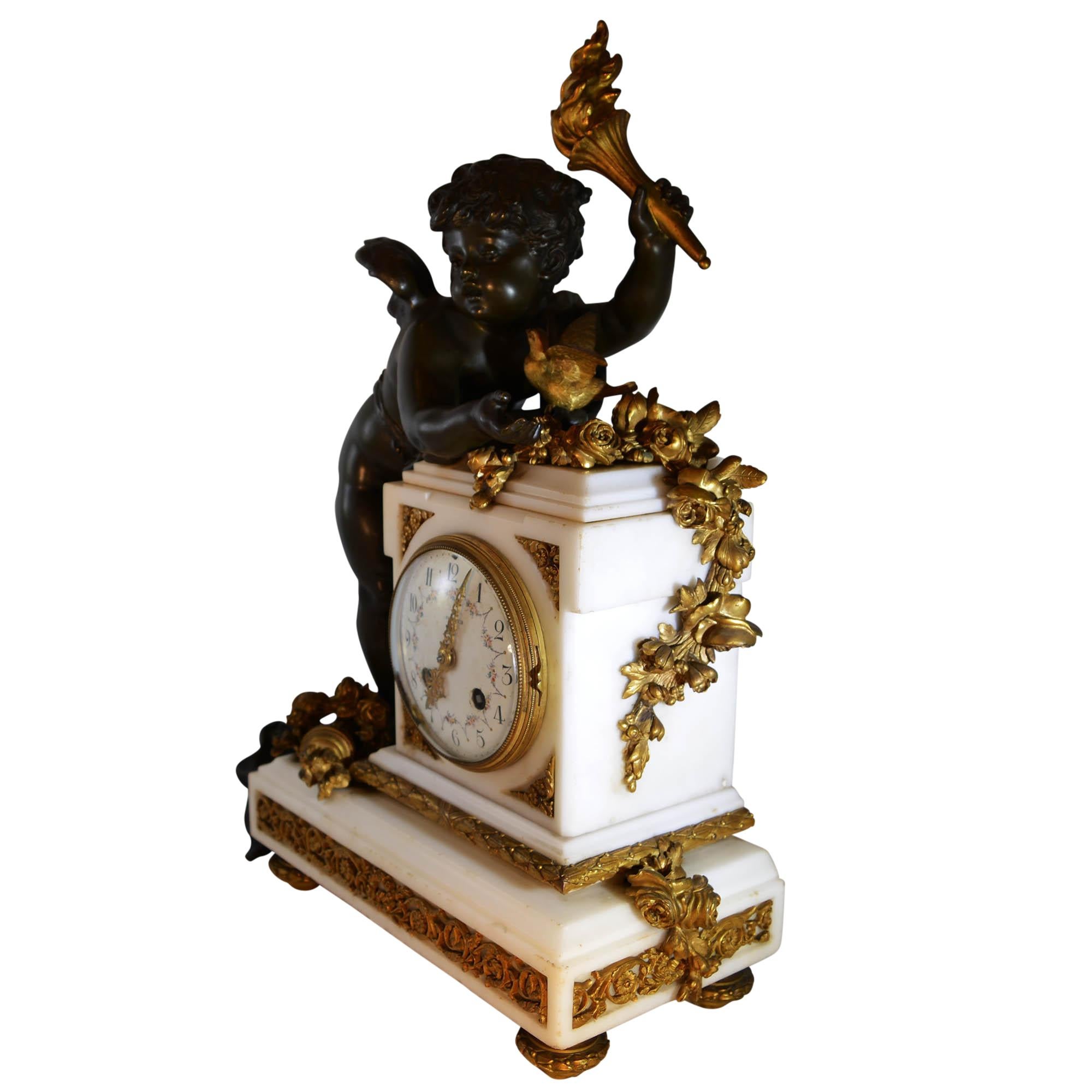 Magnificent antique Louis XVI style gilded ormolu and white marble mantel clock with a cherub of beautiful patina color holding a torch leaning against the clock. The cherub is accompanied by a bird with outstretched wings. The base is extremely
