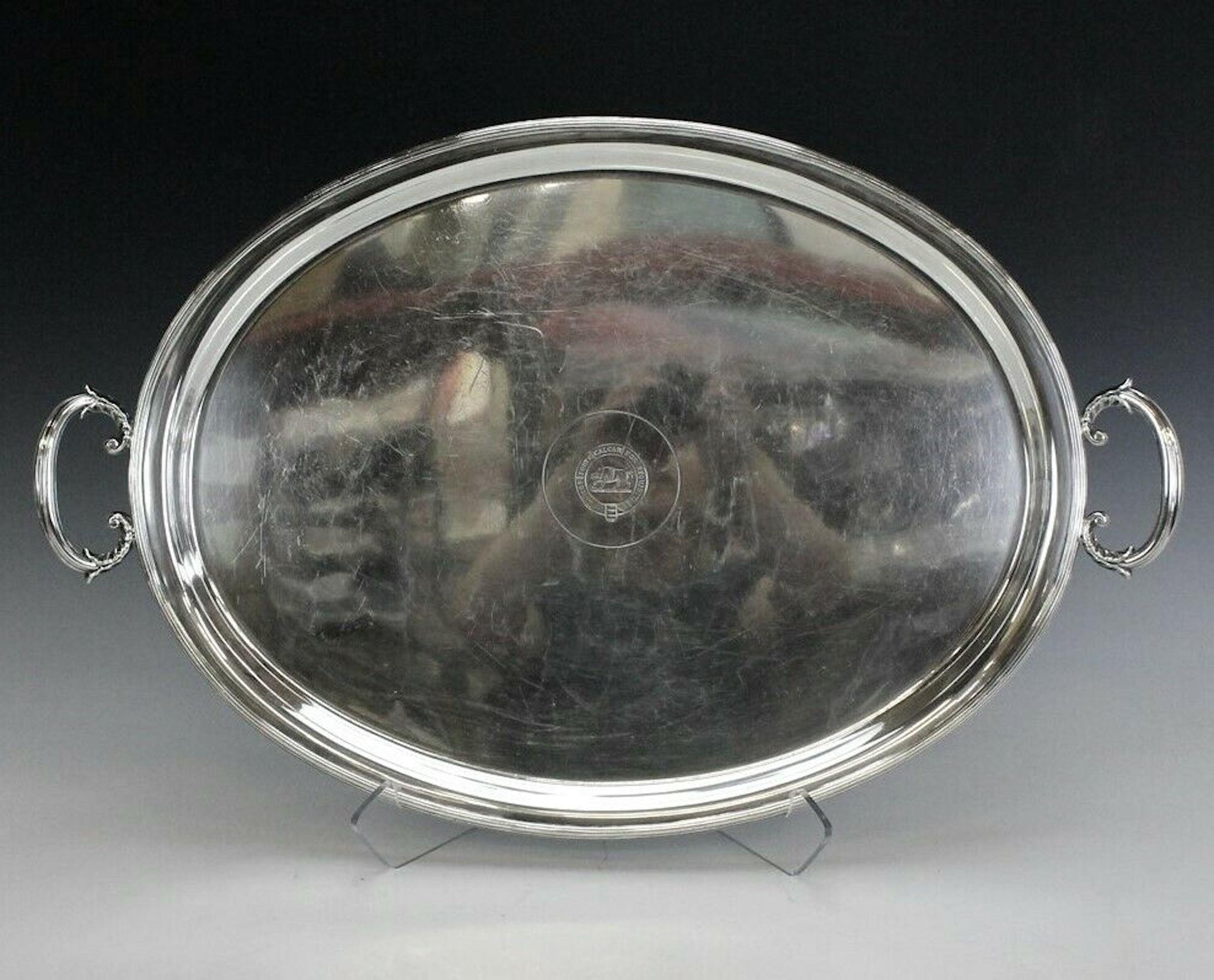 Antique Mappin Brothers Regency Style Silverplated Oval Handled Tray

Encounter a luxurious slice of history with our Antique Mappin Brothers regency style silver plated oval handled tray. Its notable center showcases a bold armorial crest featuring