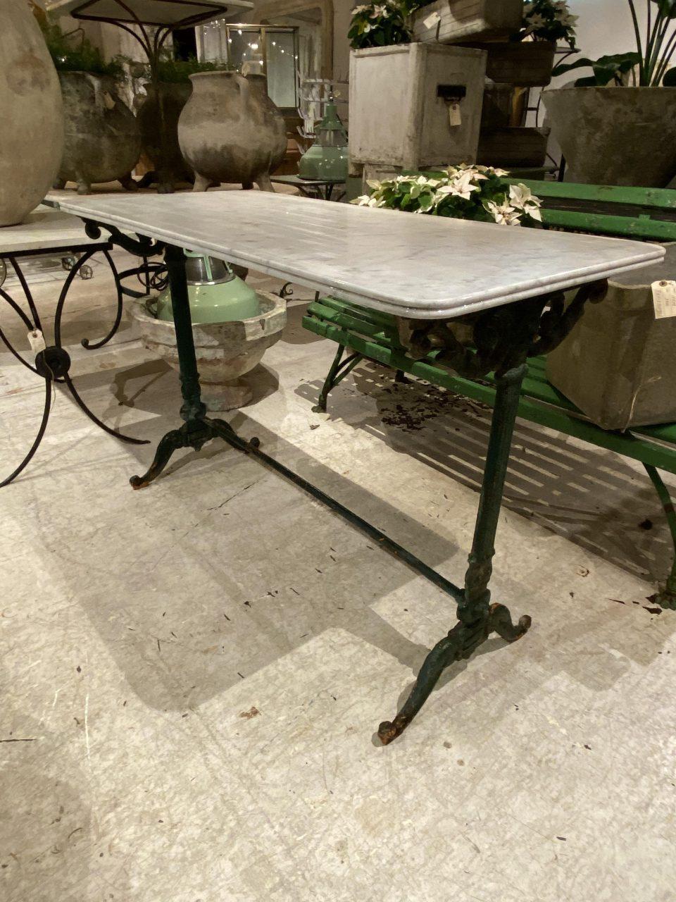 Handsome antique French outdoor table, with a marble counter top. This fantastic piece has a beautiful cast iron frame, and remnants of lovely green paint and genuine weathered patina.