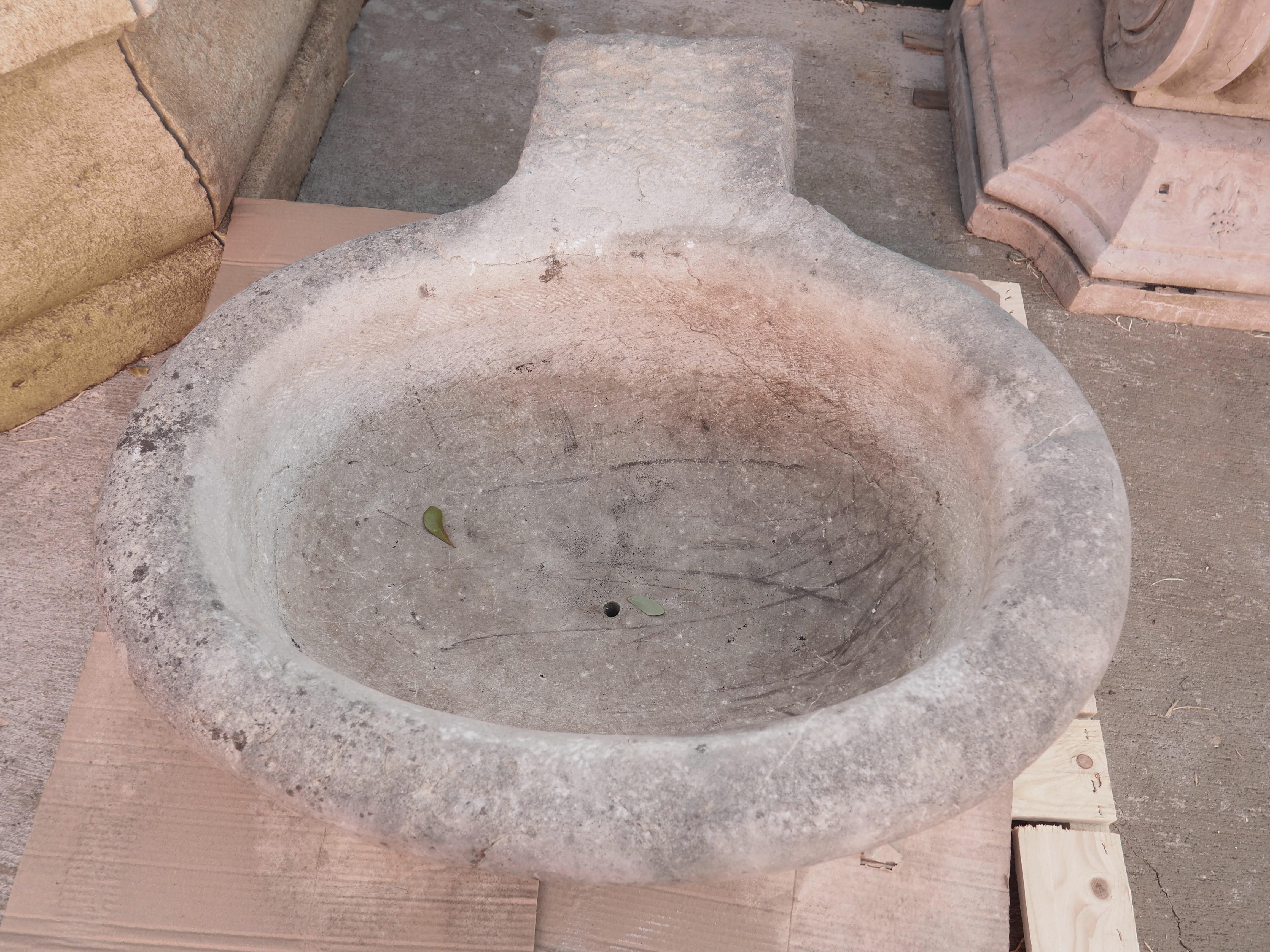 Salvaged from the garden of an Italian villa, this marble basin was hand-carved in the early 1900’s and most recently used as a planter. The ovate shaped bowl has an exterior width of 31 inches and has a small drainage hole in the bottom. A square,