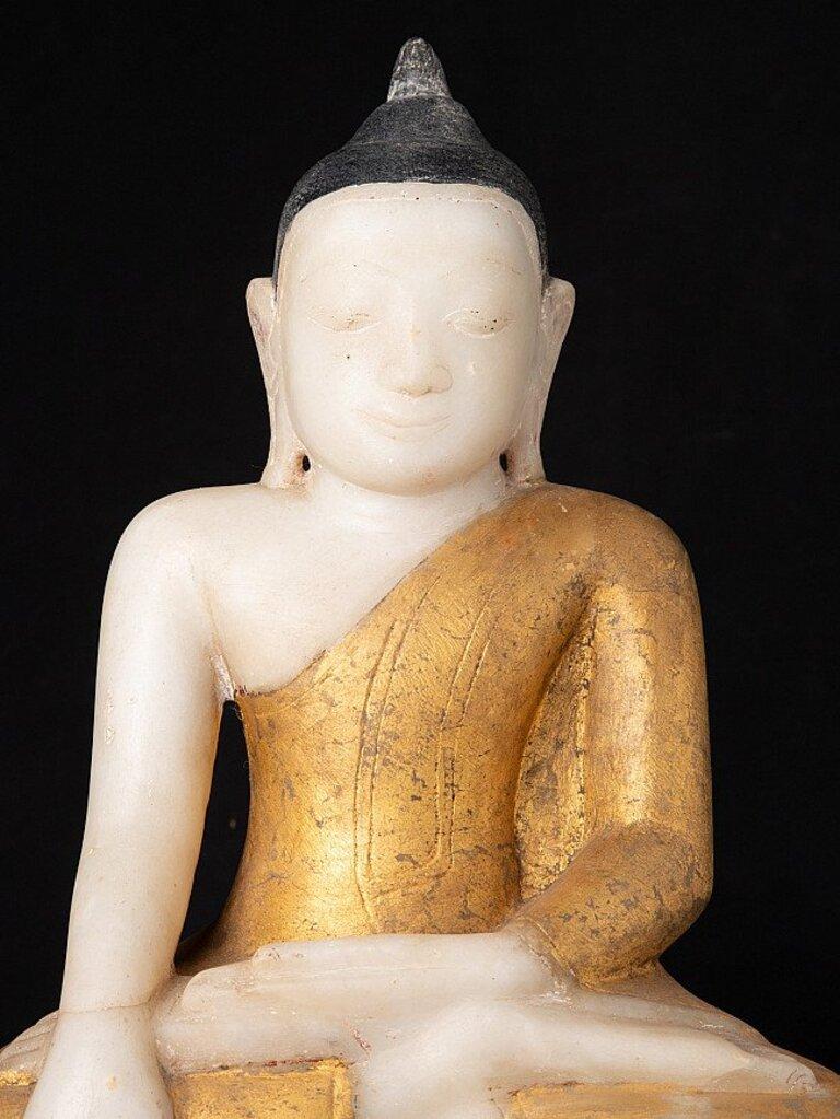 Material: marble
45 cm high 
26,3 cm wide and 16,5 cm deep
Weight: 17.5 kgs
Gilded with 24 krt. gold
Ava style
Bhumisparsha mudra
Originating from Burma
18th century
Probably regilded in the 19th or early 20th century.
 