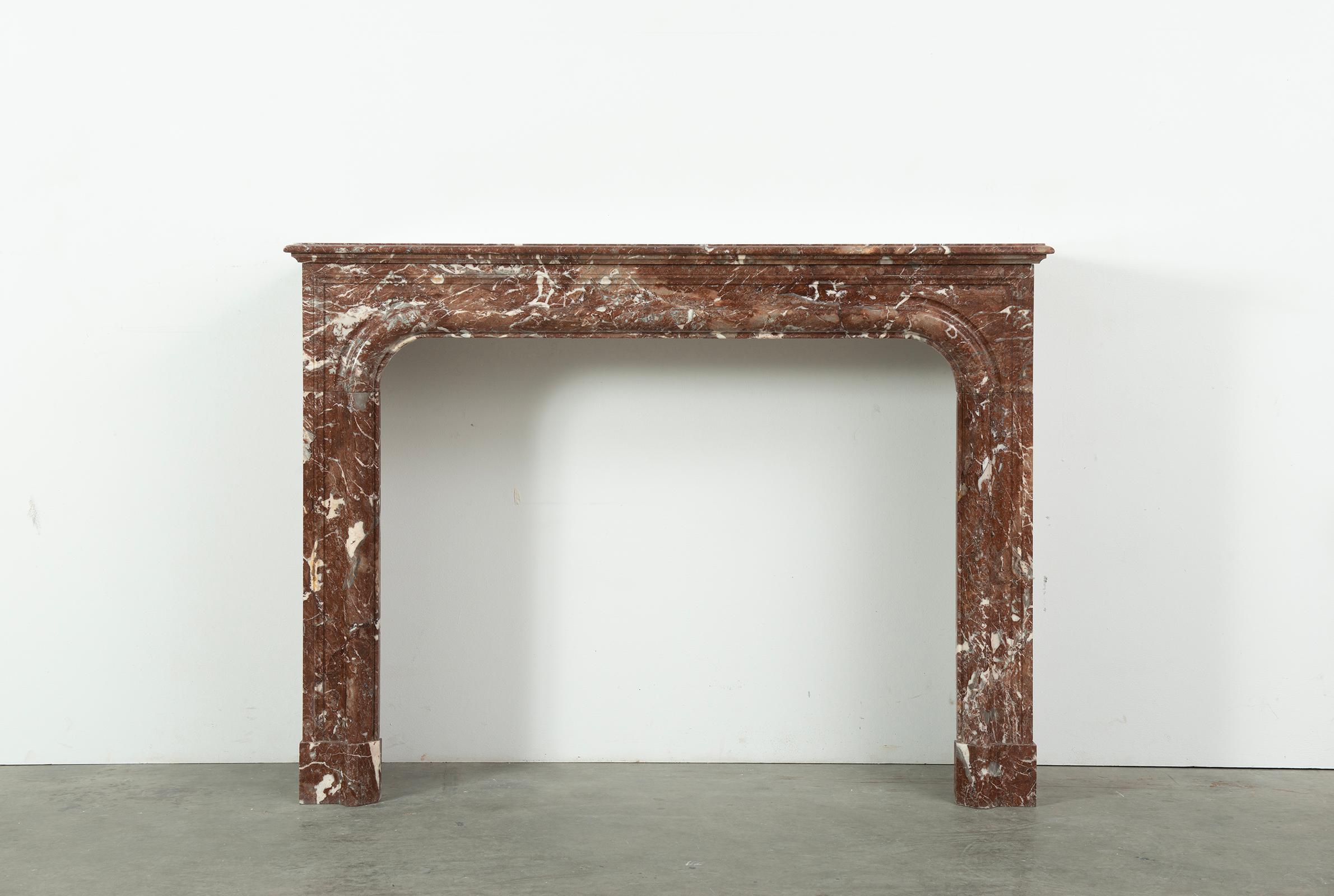 Antique Boudin Style Fireplace in warm red marble.

Lovely, simple yet elegant styled French fireplace from the 19th century.
This warm red colored manel came from a nice estate just outside of the city of Rouen.

The crisp lines and varied