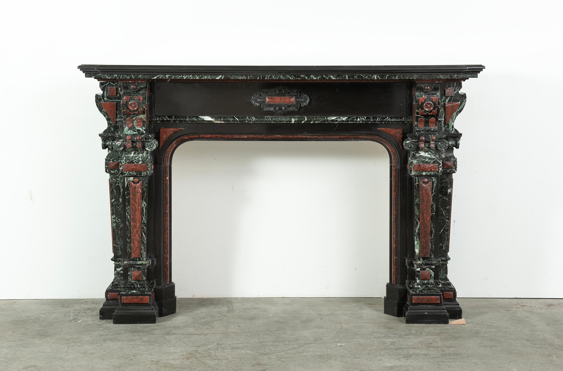 A very ornate, colorful and impressive Dutch fireplace mantel.

This multi colored marble mantel is made from a very nice quality deep black marble from Belgium and decorations in red 