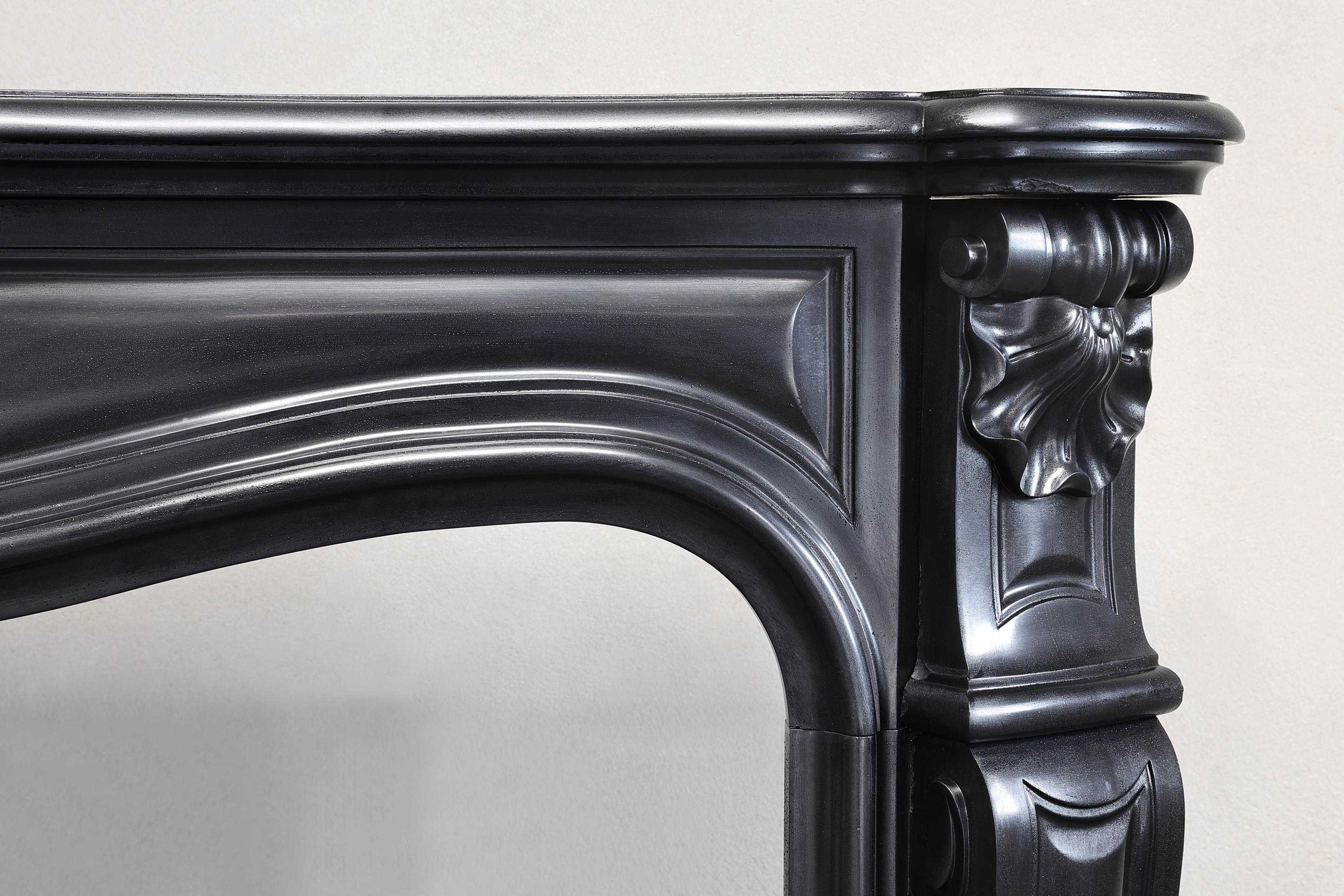 French antique marble fireplace of Noir de Mazy marble in style of Louis XV 19 cent For Sale