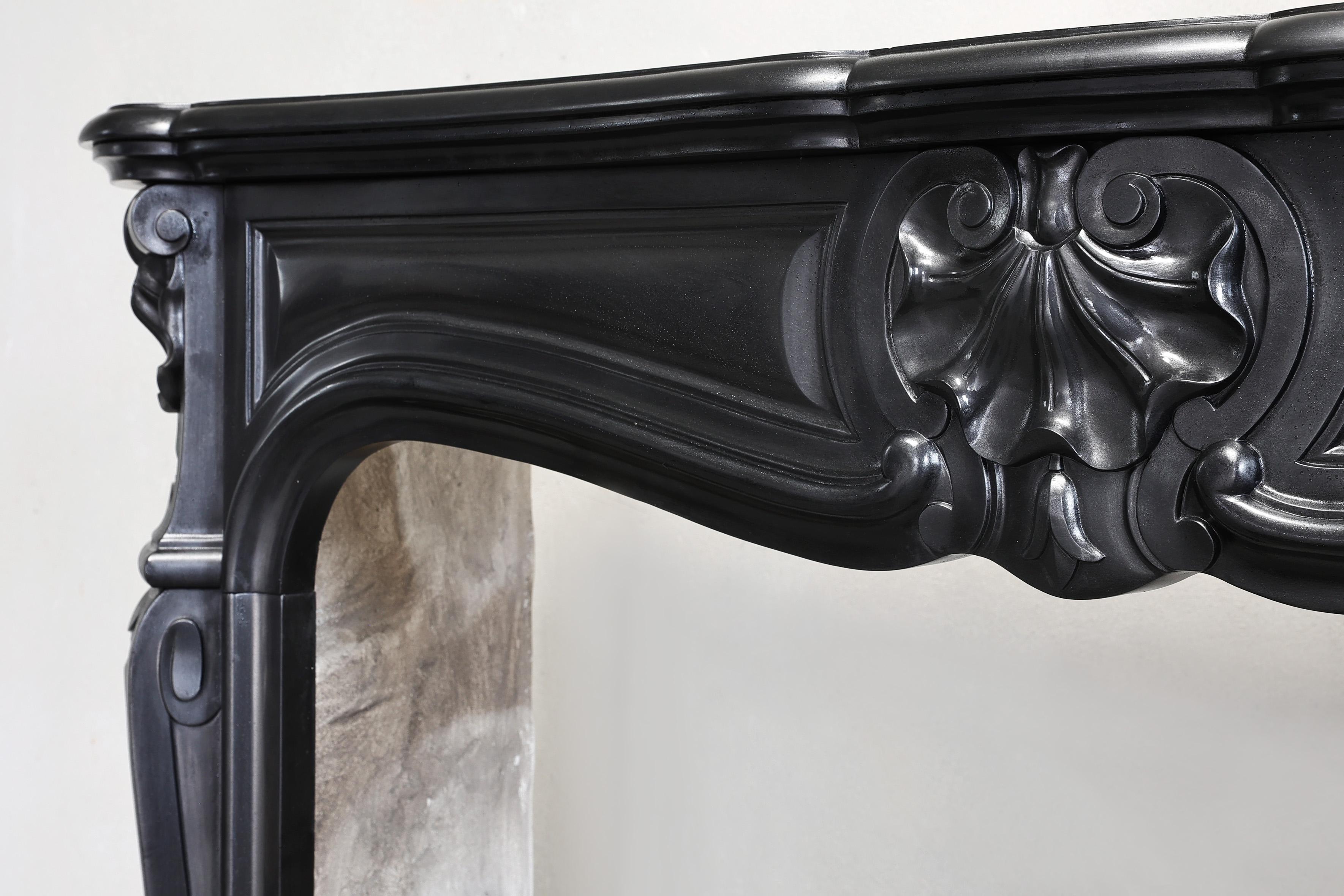 Marble antique marble fireplace of Noir de Mazy marble in style of Louis XV 19 cent For Sale