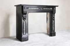 antique marble fireplace of Noir de Mazy marble in style of Louis XVI