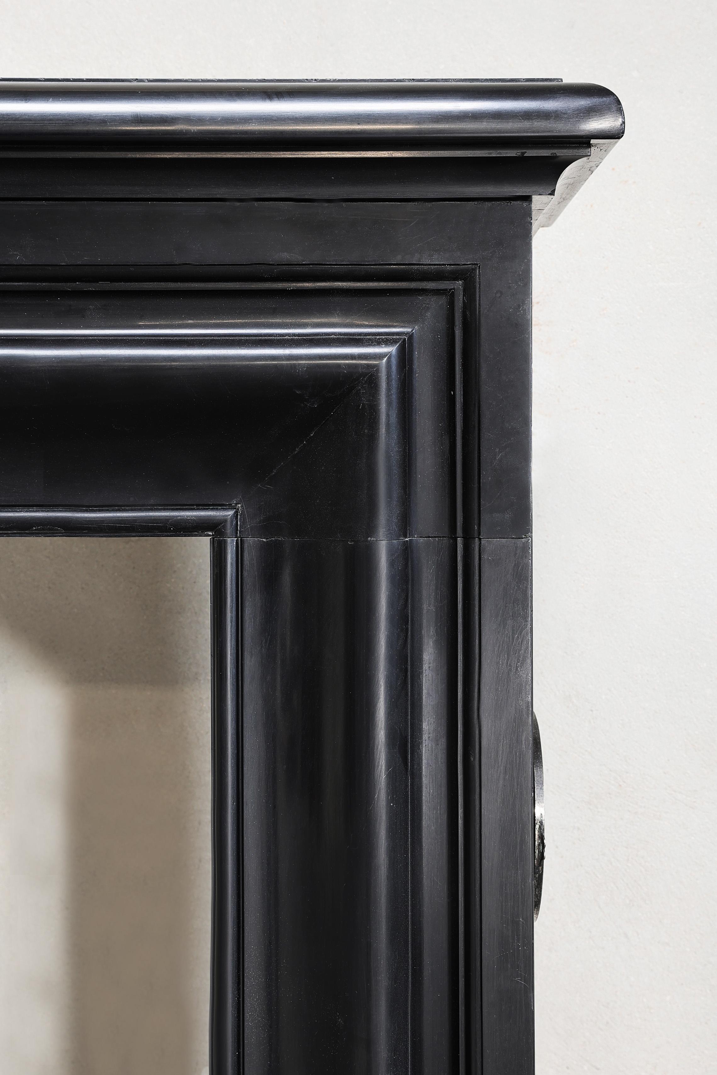 Marble antique marble fireplace of Noir de Mazy marble in style of Louis XVI For Sale