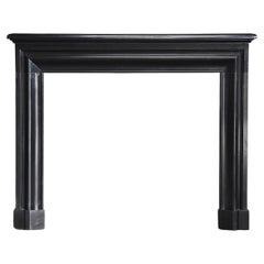 antique marble fireplace of Noir de Mazy marble in style of Louis XVI