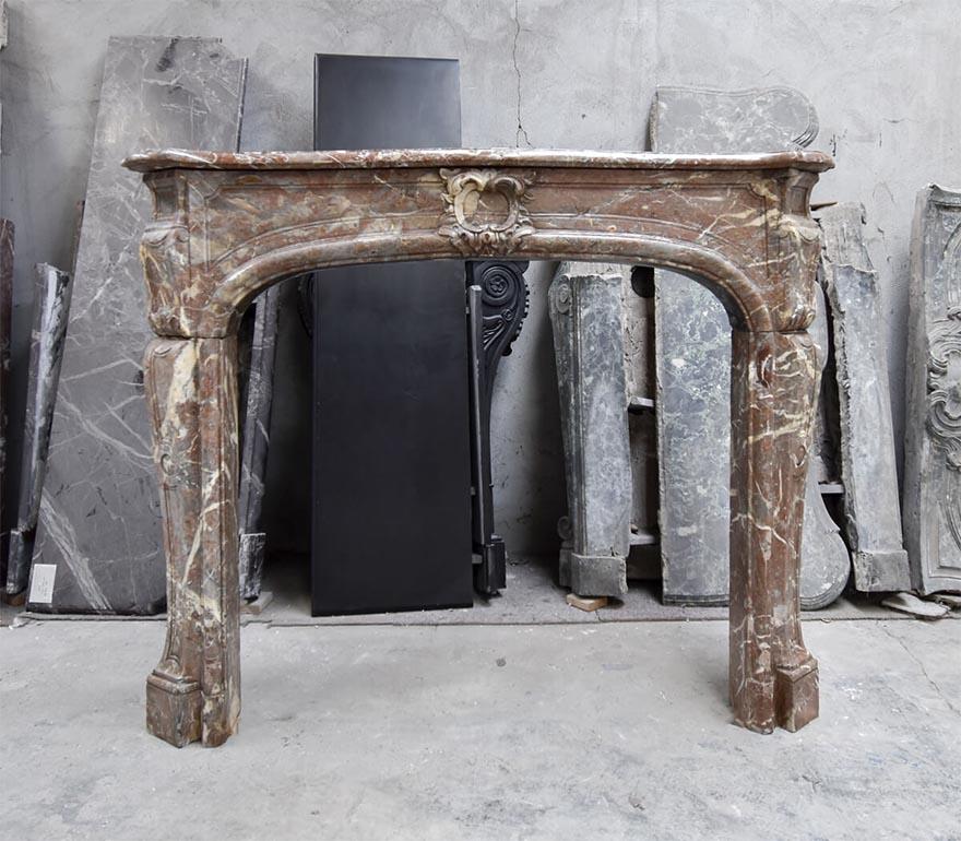 Beautiful Antique marble Louis XV fireplace mantel from the 19th Century
to place in front of the chimney. Made out of Rouge Royal Marble.