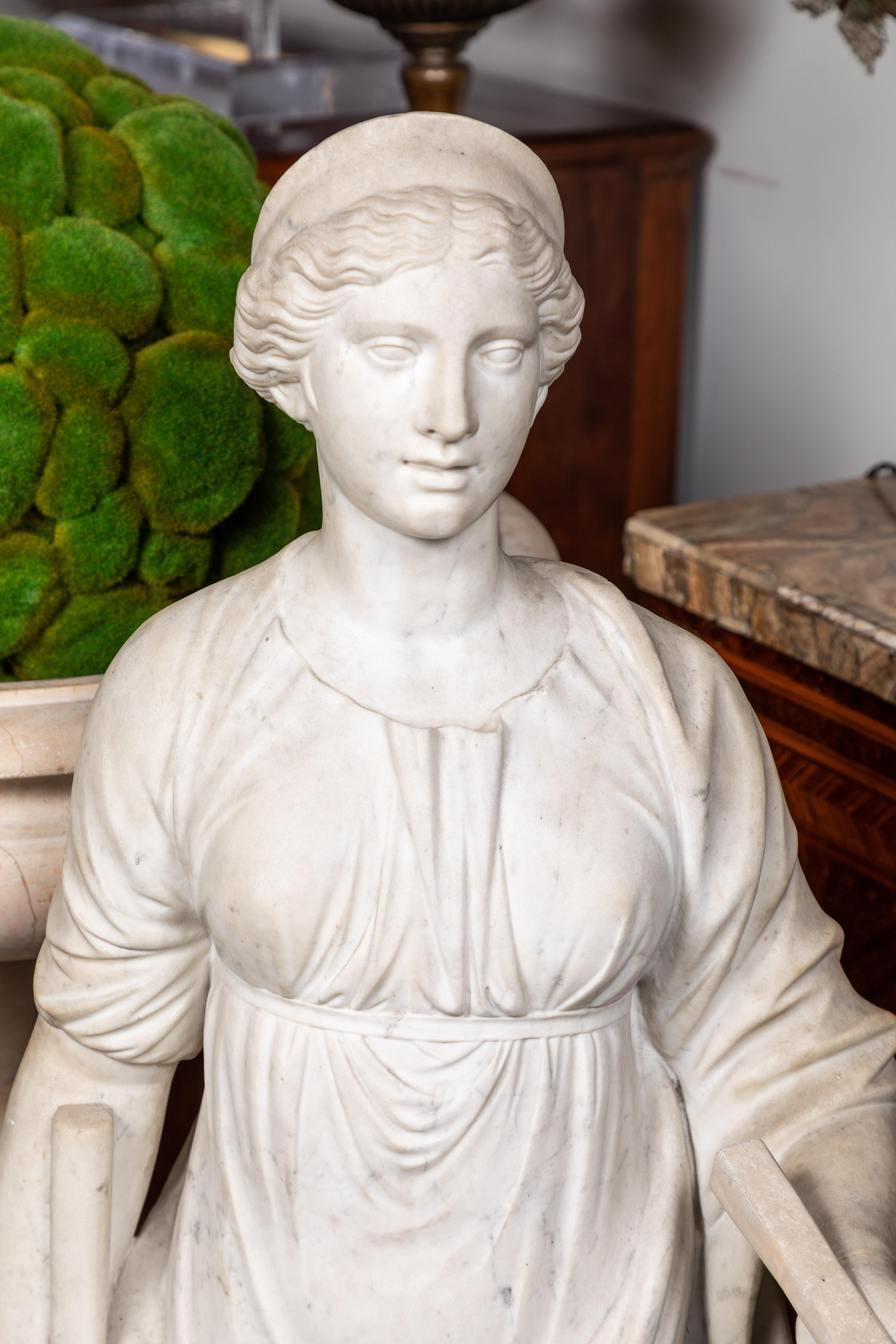 Stunningly hand carved, large, circa 1825, solid Carrara marble statue of the crowned, Roman goddess, Juno- known in ancient times as the ruler of marriage, home, and family, a champion of women, and protector of the Roman state.