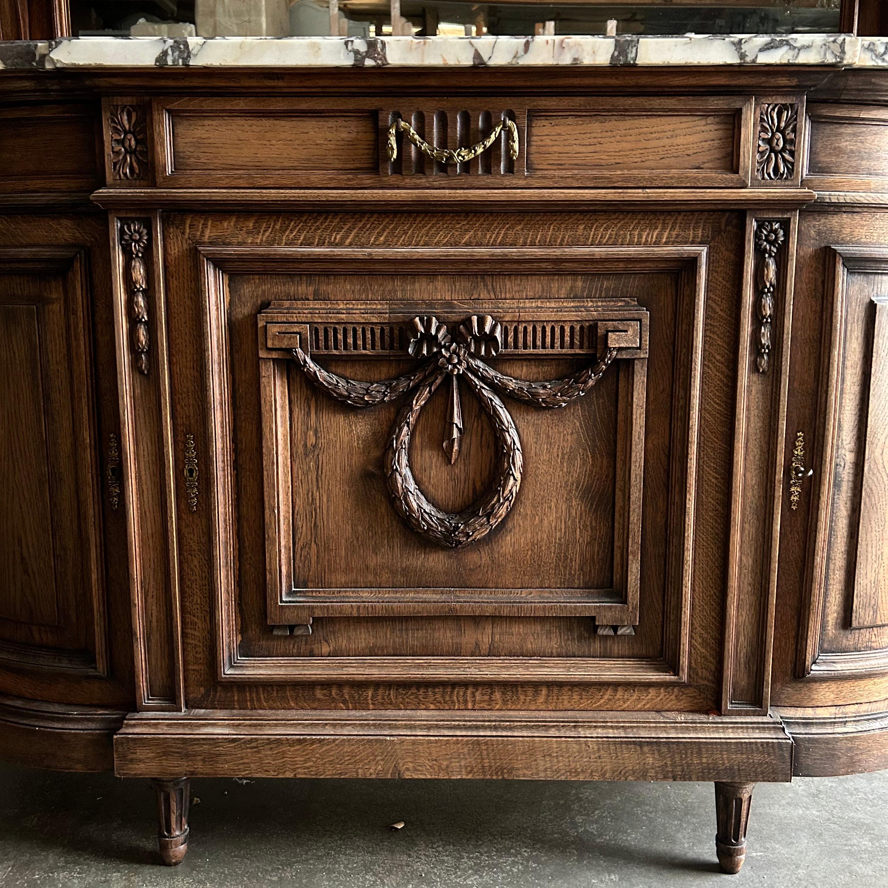 Beautiful wood carved ribbon Antique Breccia marble top Oak hunters cabinet. Great for displaying fine china and collectables, Hunters cabinet 66”w x 24”d x 83”h
Countertop: 40”h
Inside top shelf: 12”d
Bottom inside shelf: 19”d