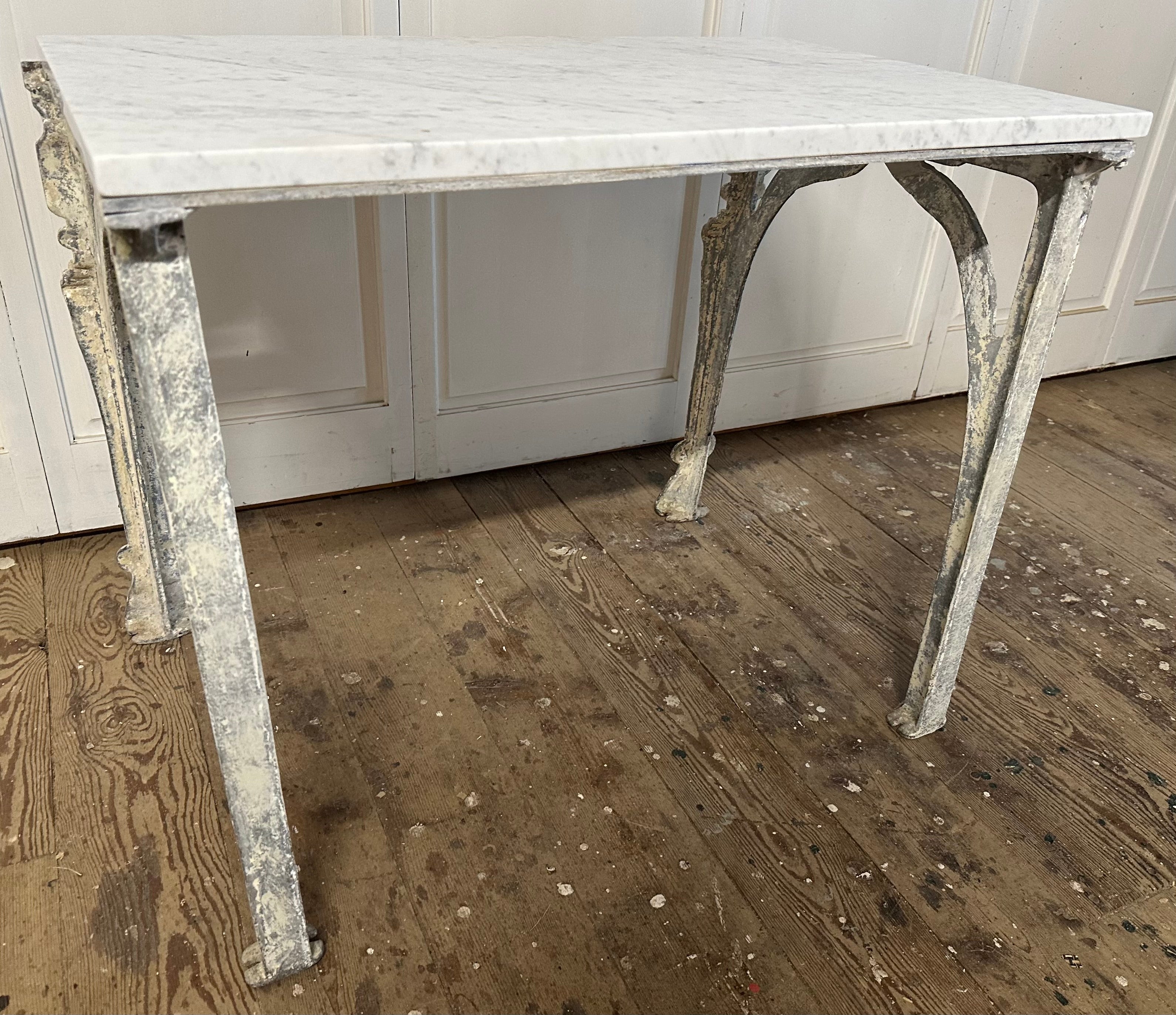 19th Century Continental metal base with fine detailing, distressed painted surface with residue of early paint, topped with white Carrara marble makes this coffee table a fine additional to any situation.
Use this table as a coffee table, side
