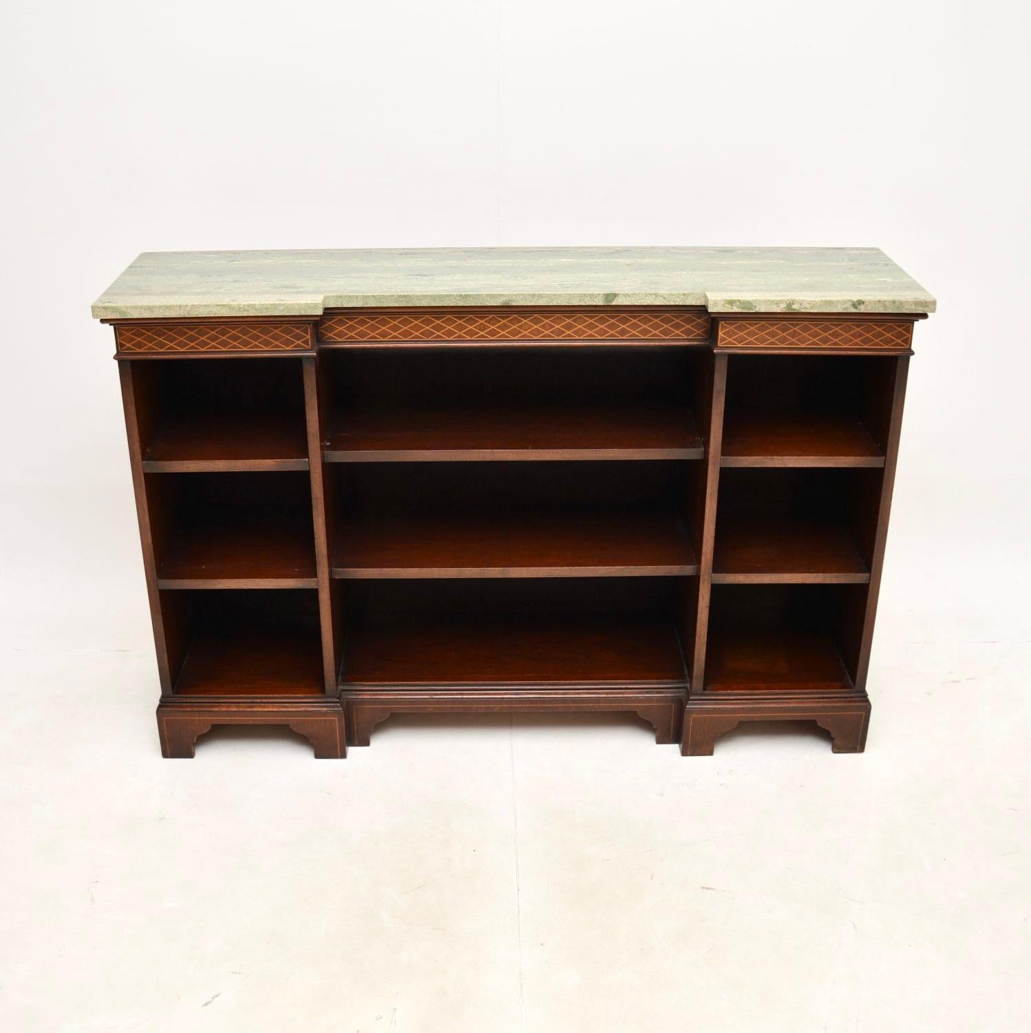 A superb antique marble top open bookcase / sideboard. This was made in England, it dates from around the 1910-20’s.

This has a lovely inverted breakfront design, with a gorgeous light green marble top. The front is open with lots of adjustable