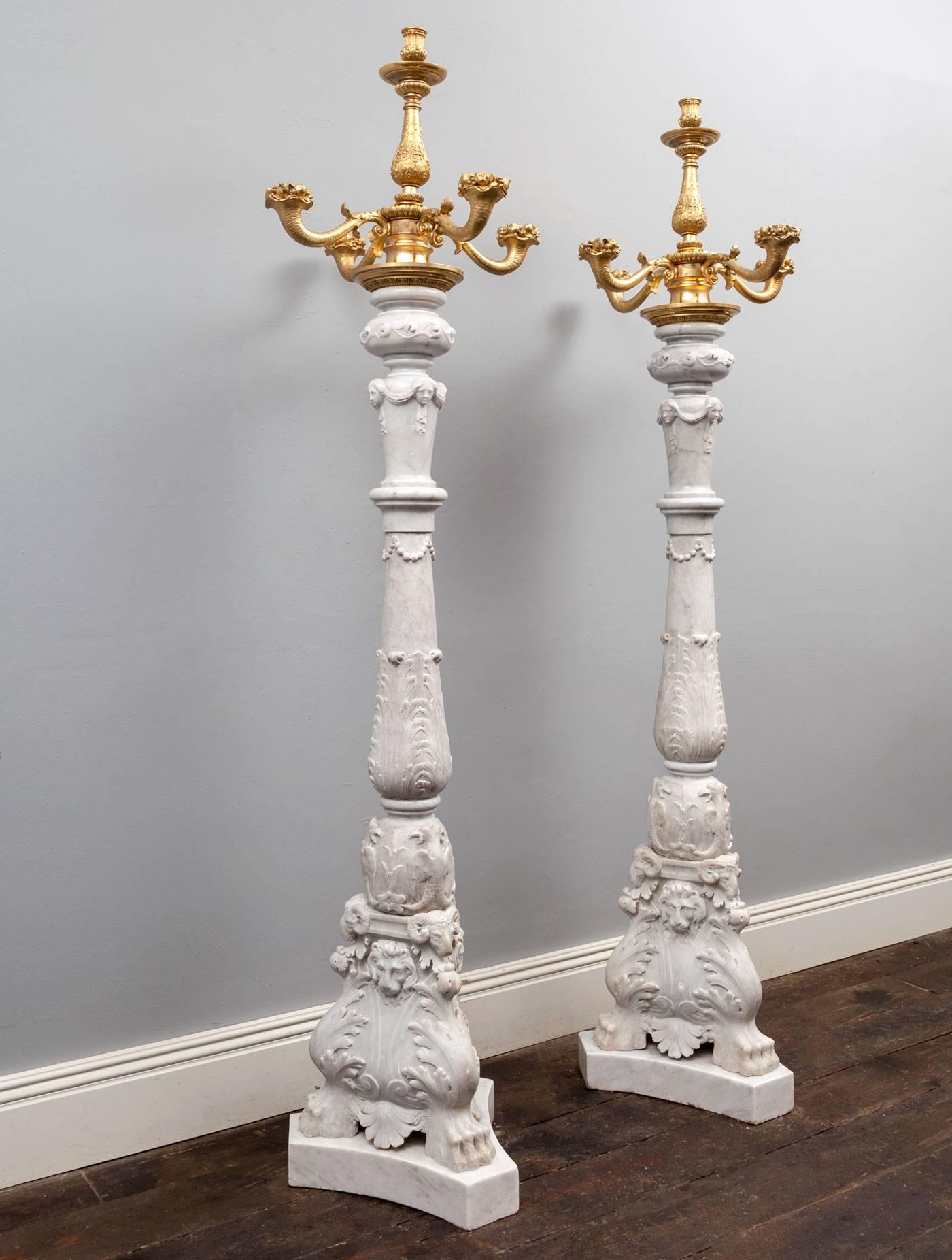 An exceptional pair of antique white Carrara marble and ormolu candelabra toucheres. Baroque in style and made during the 19th century in Venice, Italy. 

The bases with hairy paw-feet, acanthus leaves, lions masks and rams heads. The baluster