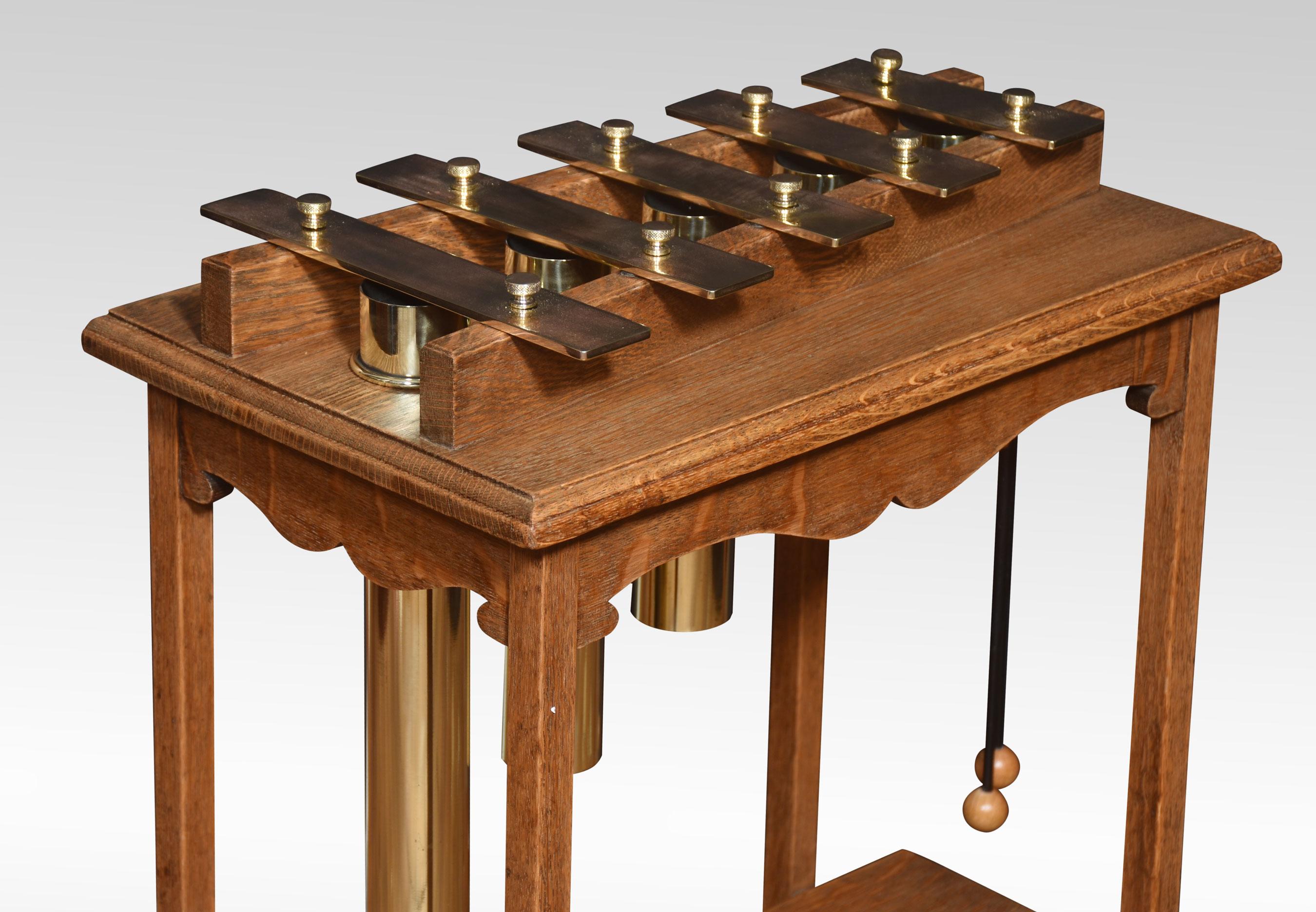 Oak cased glockenspiel, the solid oak frame supporting five brass keys with tubular brass cylinders below. All raised up on four splayed legs united by undertier.
Dimensions
Height 30 Inches
Width 20.5 Inches
Depth 13.5 Inches