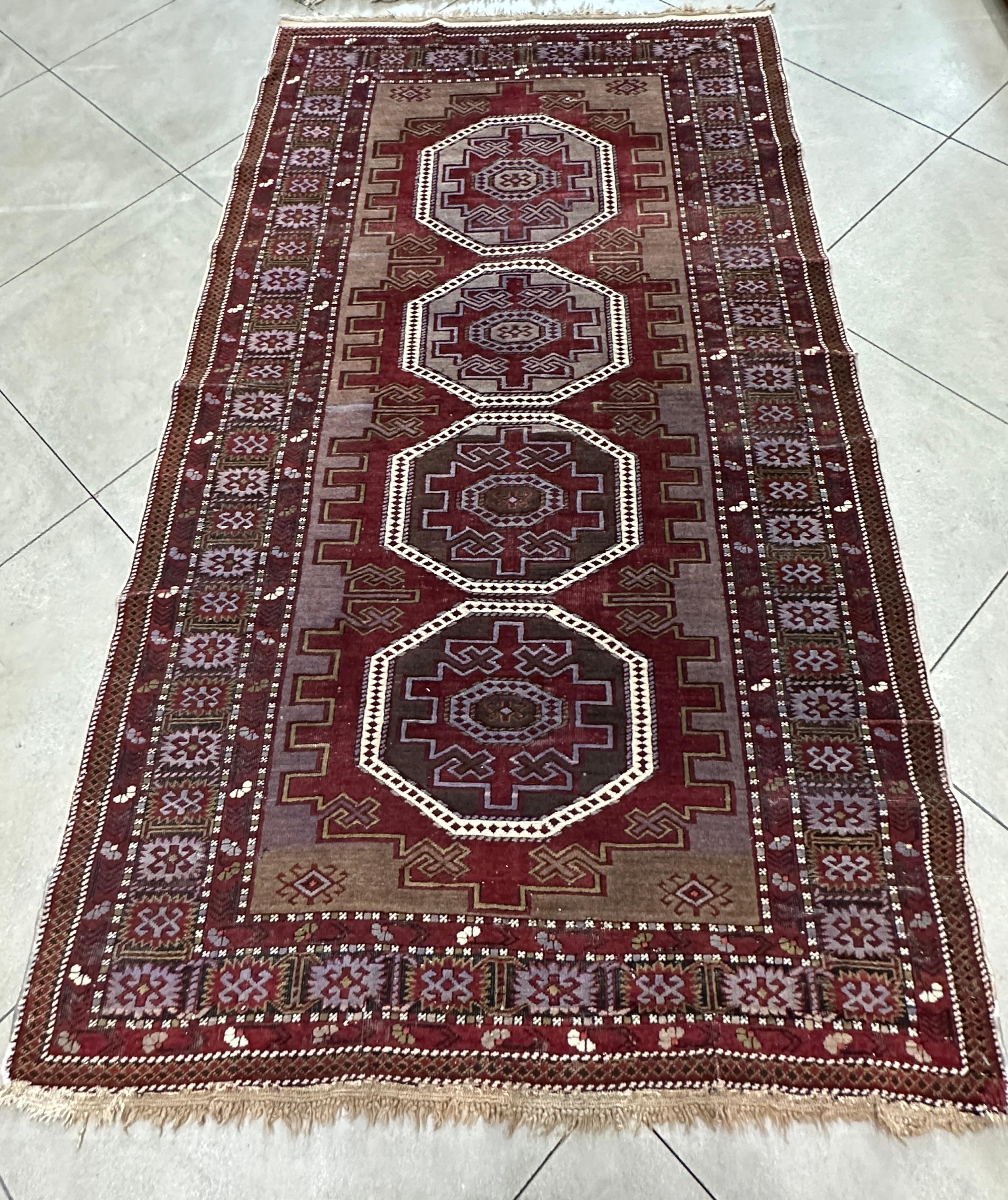 Elevate your home décor with the timeless elegance of our Old Maroon and Purple Russian Accent Rug. This exquisite piece embodies the rich heritage of Russian craftsmanship, featuring intricate patterns and a striking color palette of deep maroon