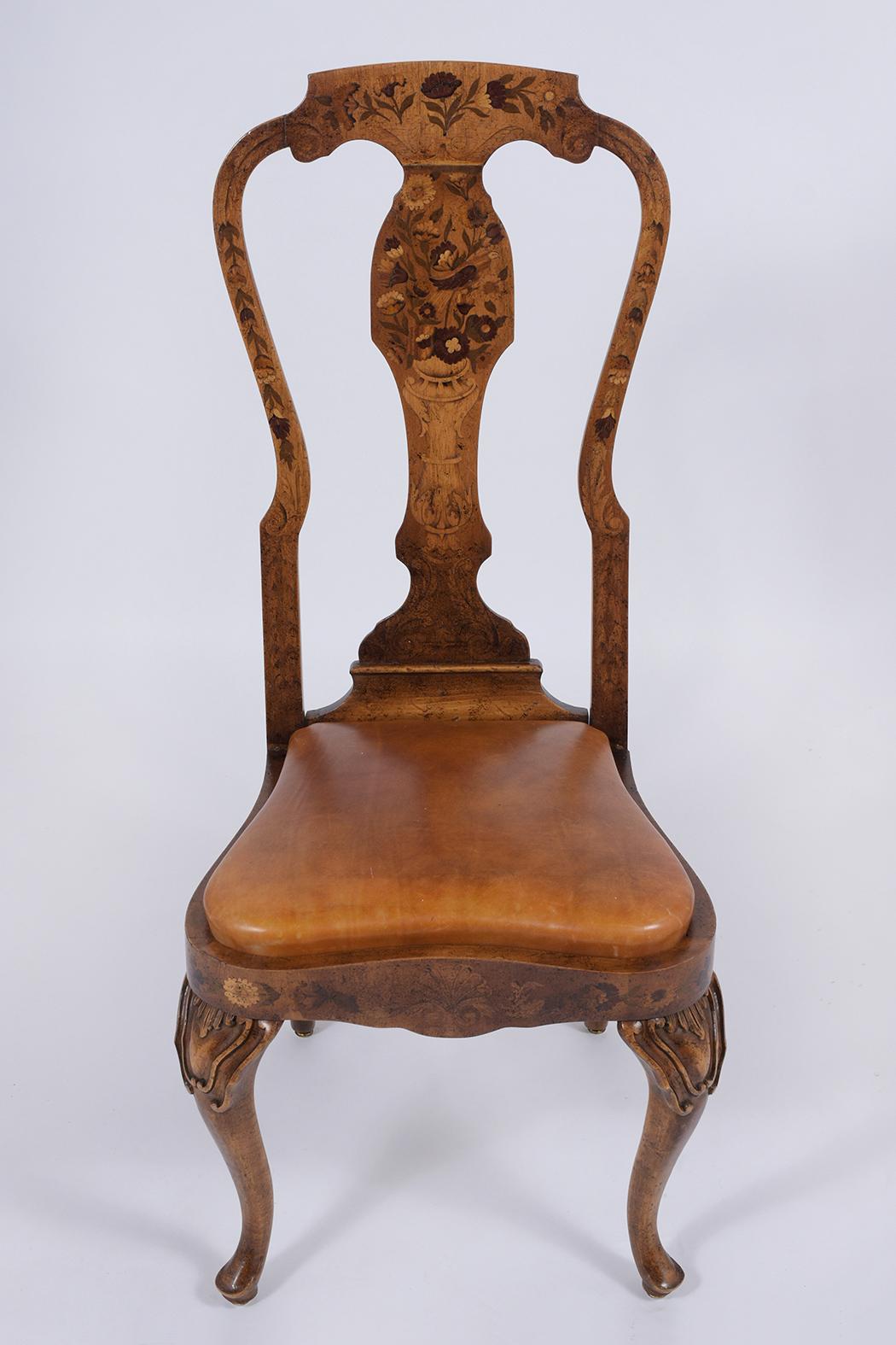 A remarkable Early 19th Century Side Chair is crafted out of cherry wood with beautiful inlaid veneers and is in great condition. This side chair features a high back carved frame with intricate inlaid details throughout and comes with an upholstery