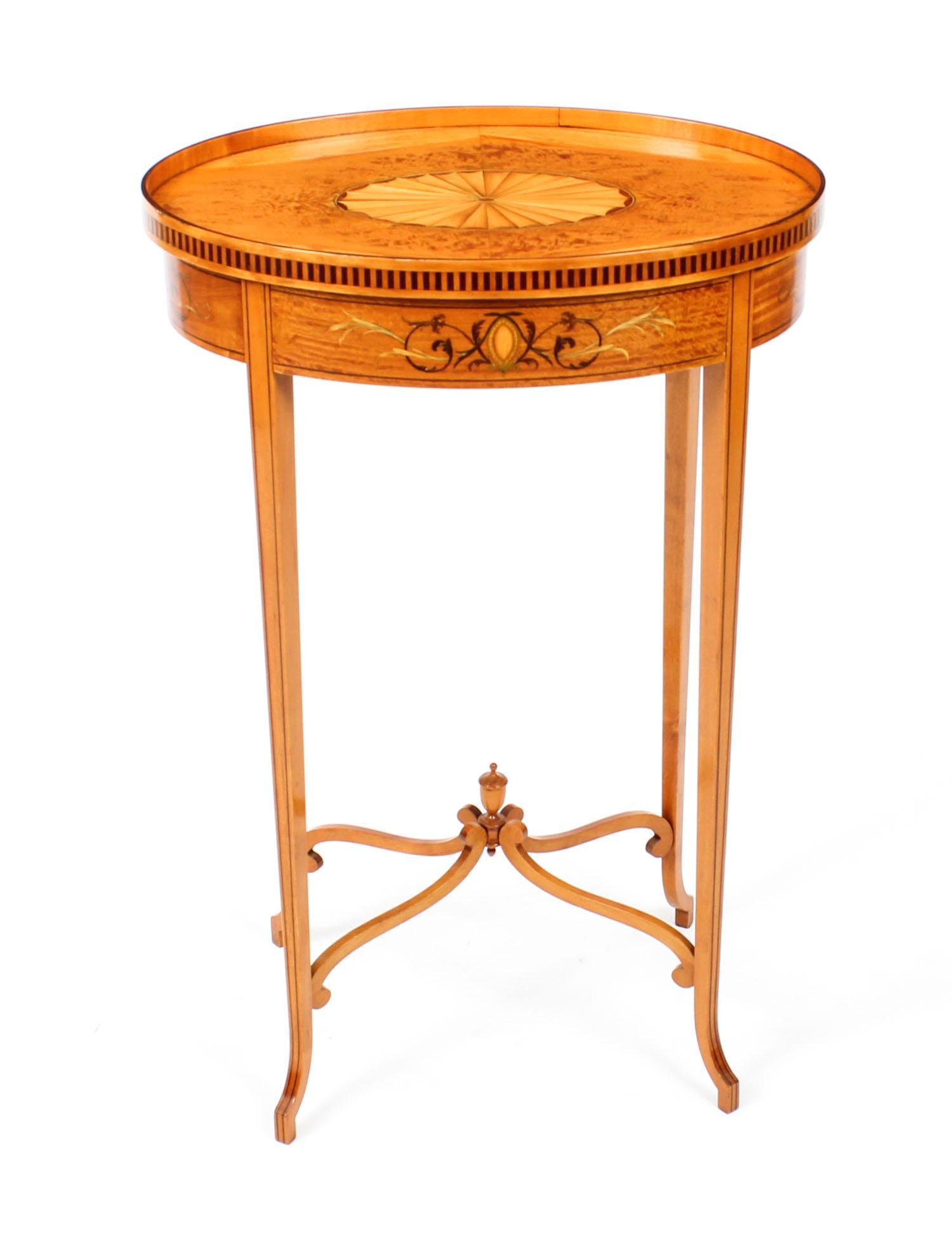 This is a superb antique satinwood oval occasional table, circa 1880 in date.

The table is exquisitely crafted in a rich satinwood, it features shell and floral marquetry with ebony line inlaid decoration throughout, it has a useful drawer in the