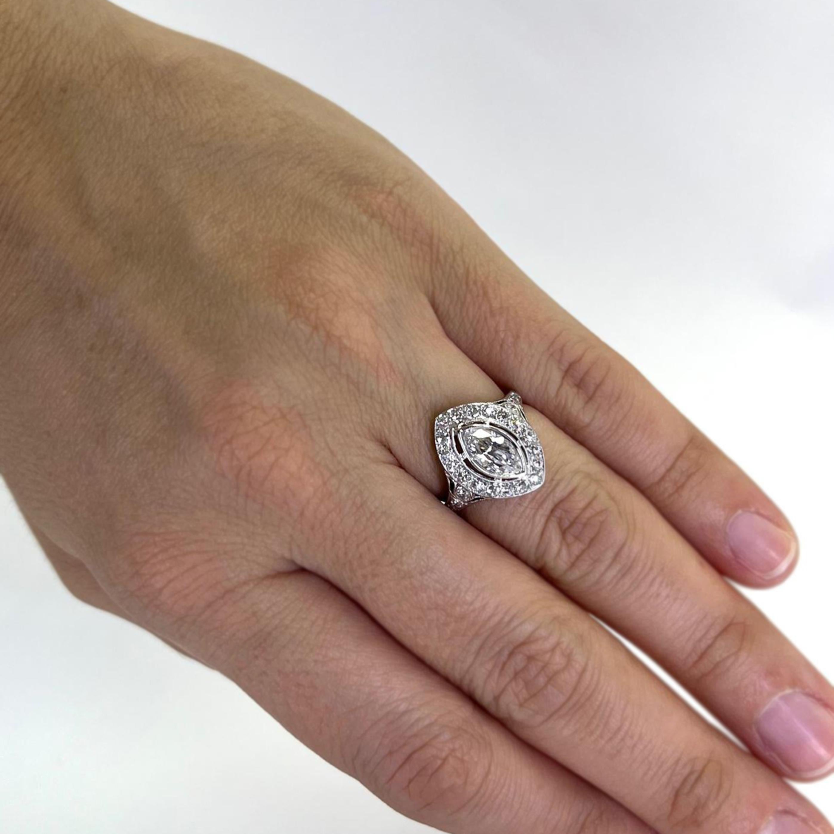 Antique Platinum Diamond Ring Featuring a Marquise Cut Diamond of VS Clarity and G Color Weighing Approximately 0.85 Carats Accented by 25 Old European and Single Cut Diamond of VS Clarity and G/H Color Totaling Approximately 1.00 Carat. Finger Size