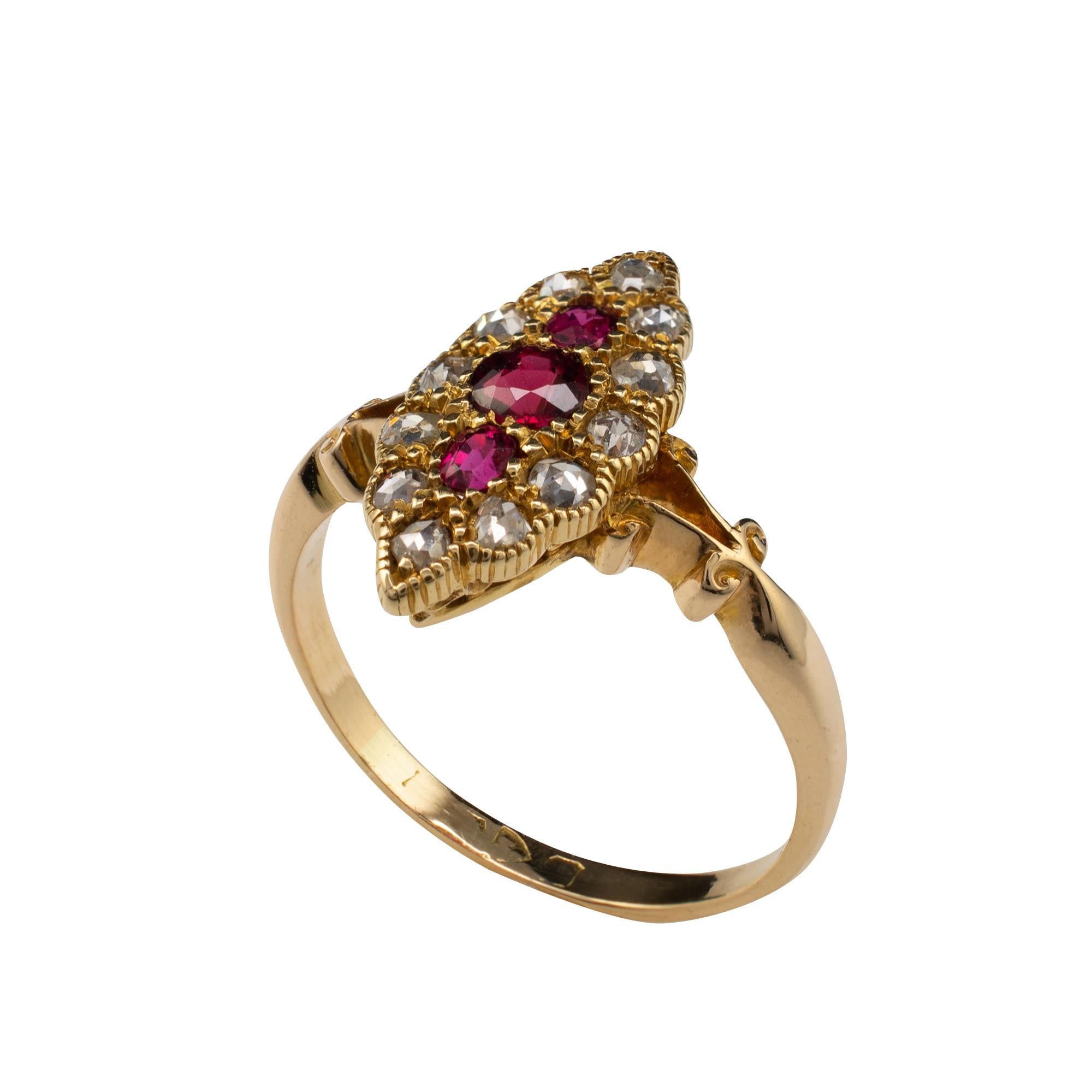 Fine quality ruby and rose-cut diamond antique ring, crafted in 18 karat yellow gold and surmounted with a vertical trio of natural rubies with 12 old rose cut diamonds. The side gallery is detailed with openwork and the bifurcated shoulders are
