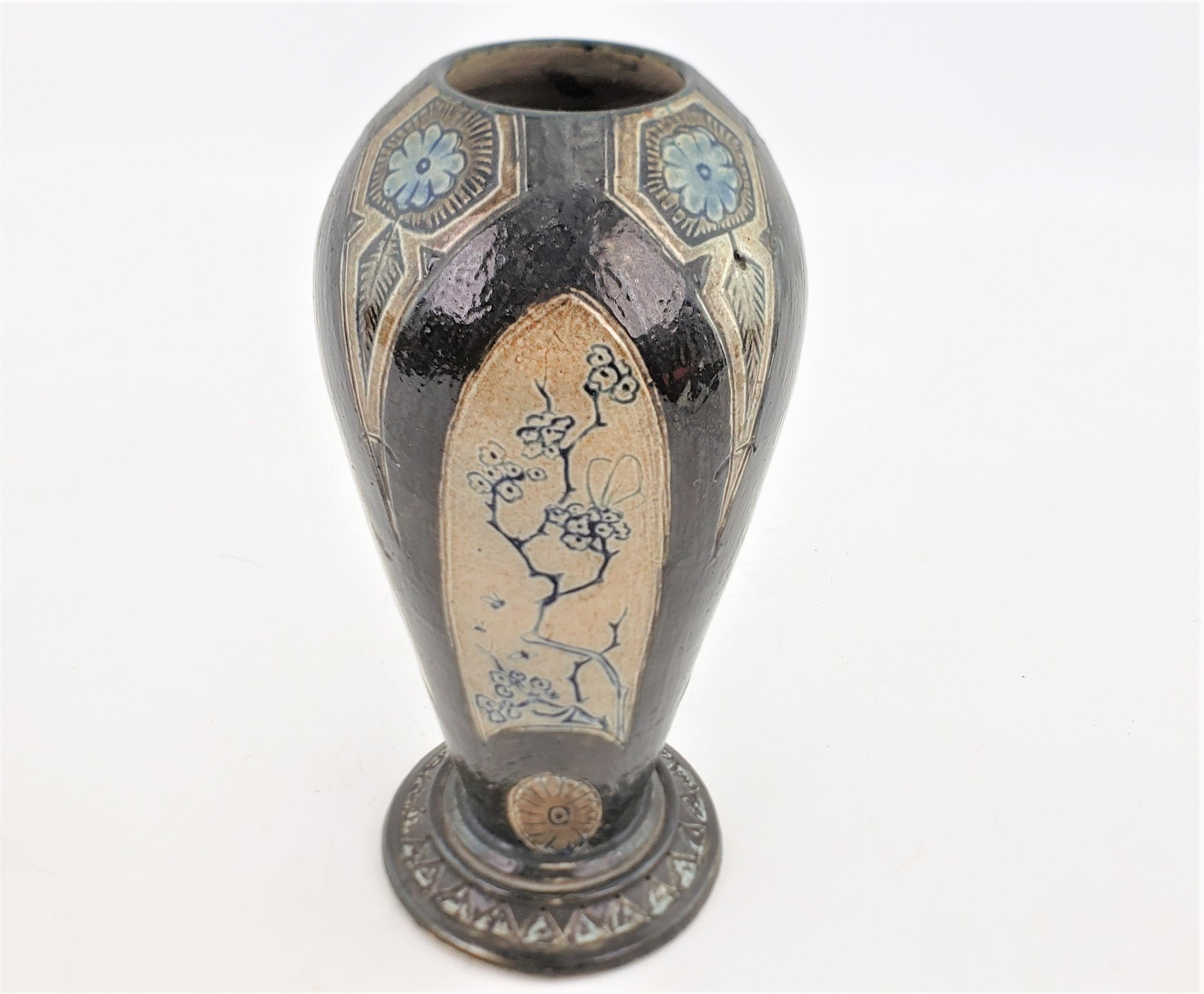 This antique hand-crafted art pottery vase was done by the renowned Martin Brothers factory of England, in approximately 1890 in the period Aesthetic Movement style. The vase is done with a glazed stoneware, and has an Asian inspired motif with blue