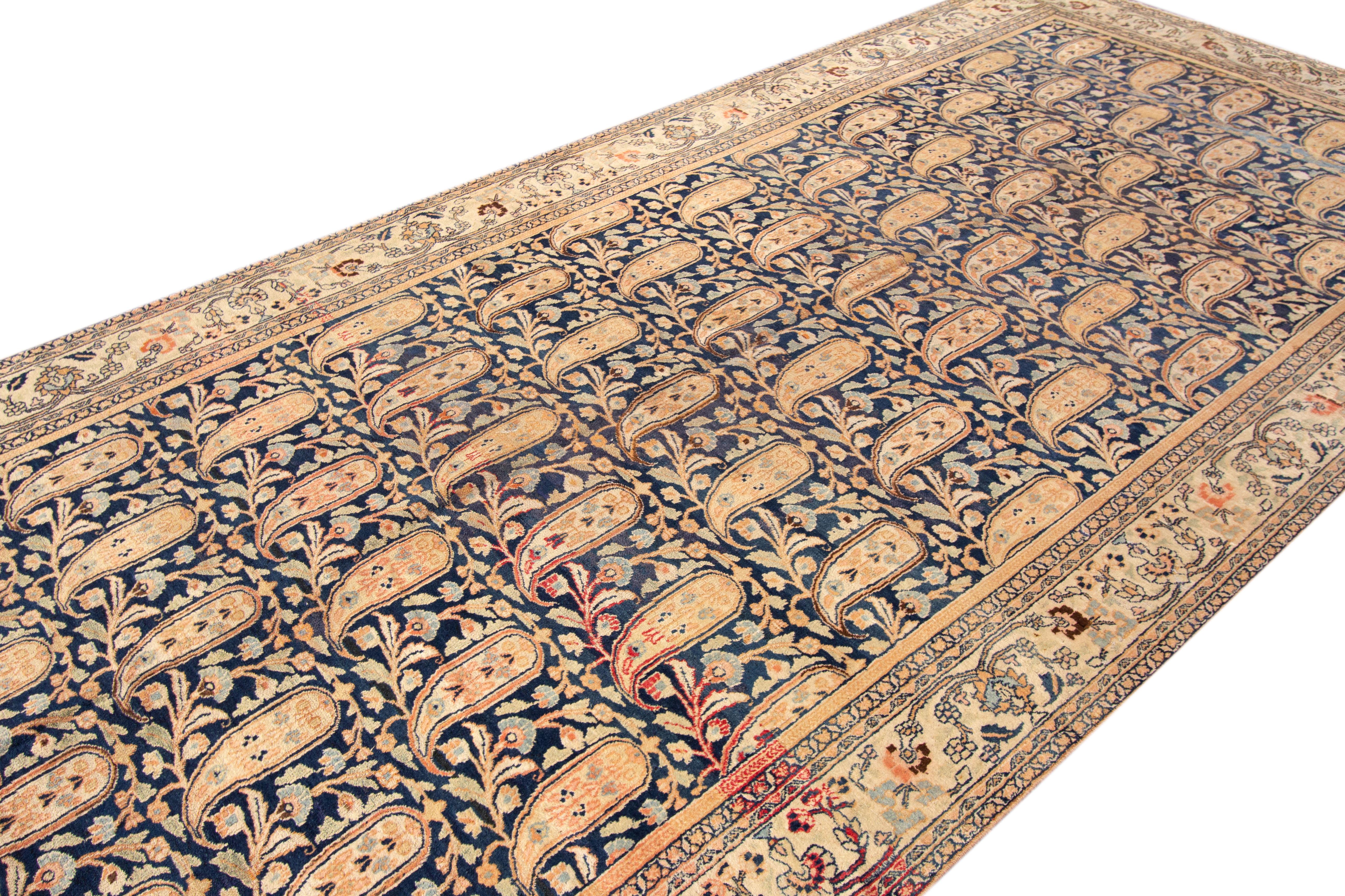 An antique Mashad gallery rug with an all over floral bayleaf motif. This rug measures at 6'6