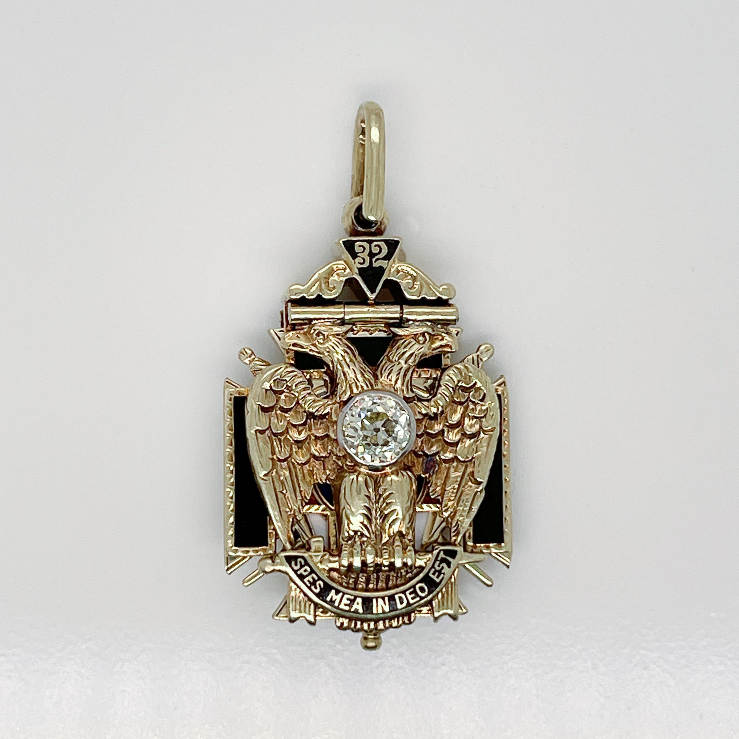 A very fine Antique Masonic 14K gold, diamond, and enamel pendant.

The three layered Masonic pendant has both a hinged front and back that open to reveal an enameled cross in the center. 

Bezel set with a beautiful round brilliant cut diamond in