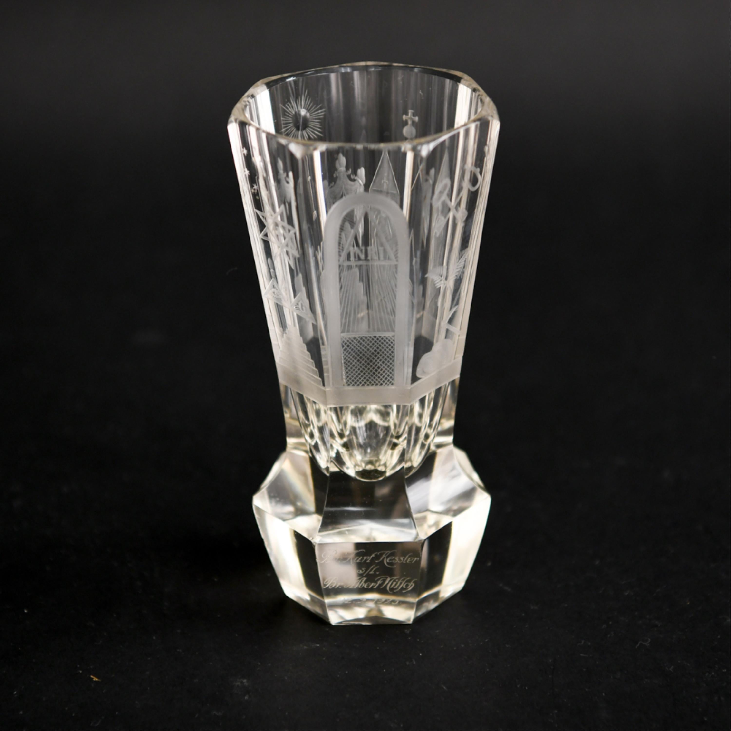 A very intricately carved and etched glass goblet with masonic symbols. Engraved dedication on base.
