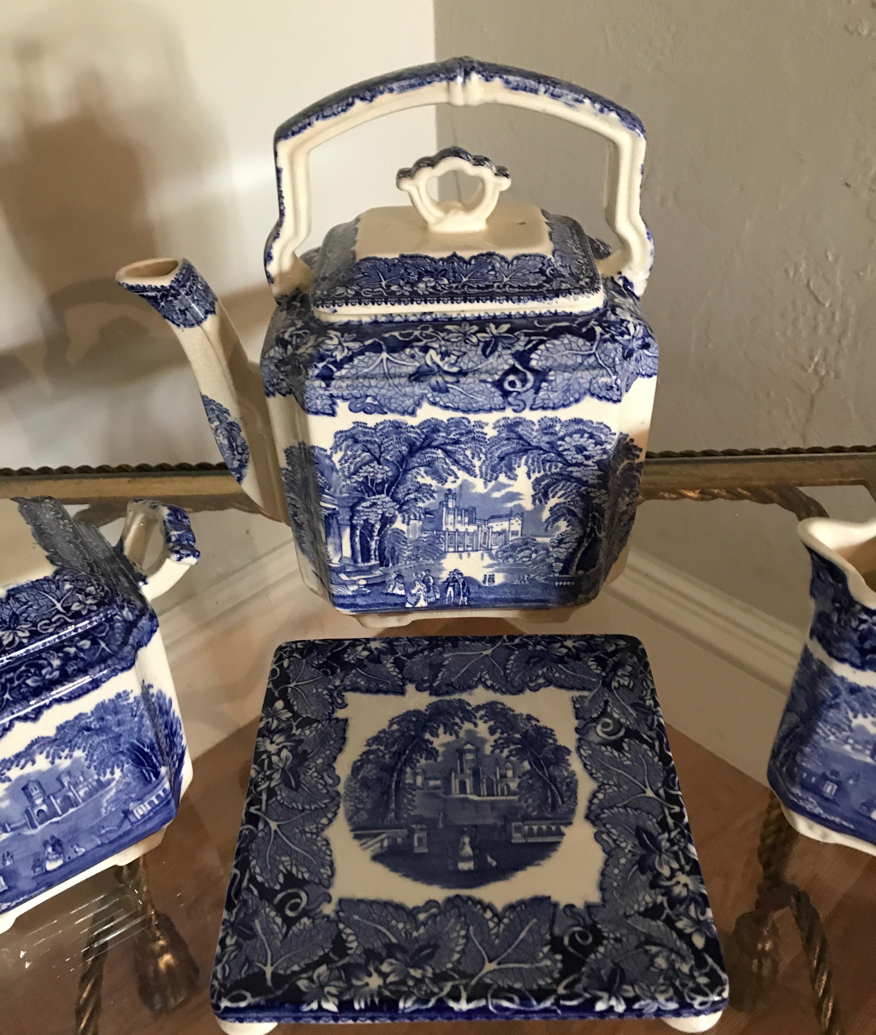 Antique blue and white Mason's ironstone vista tea set consisting of large tea pot, sugar bowl, creamer and trivet. Large tea pot is 8.5 x 5.5 x 8. Hot plate is 6 x 6. Creamer is 4.5 x 4.25 x 2.5.
Sugar bowl is 6.5 x 4 5.75.