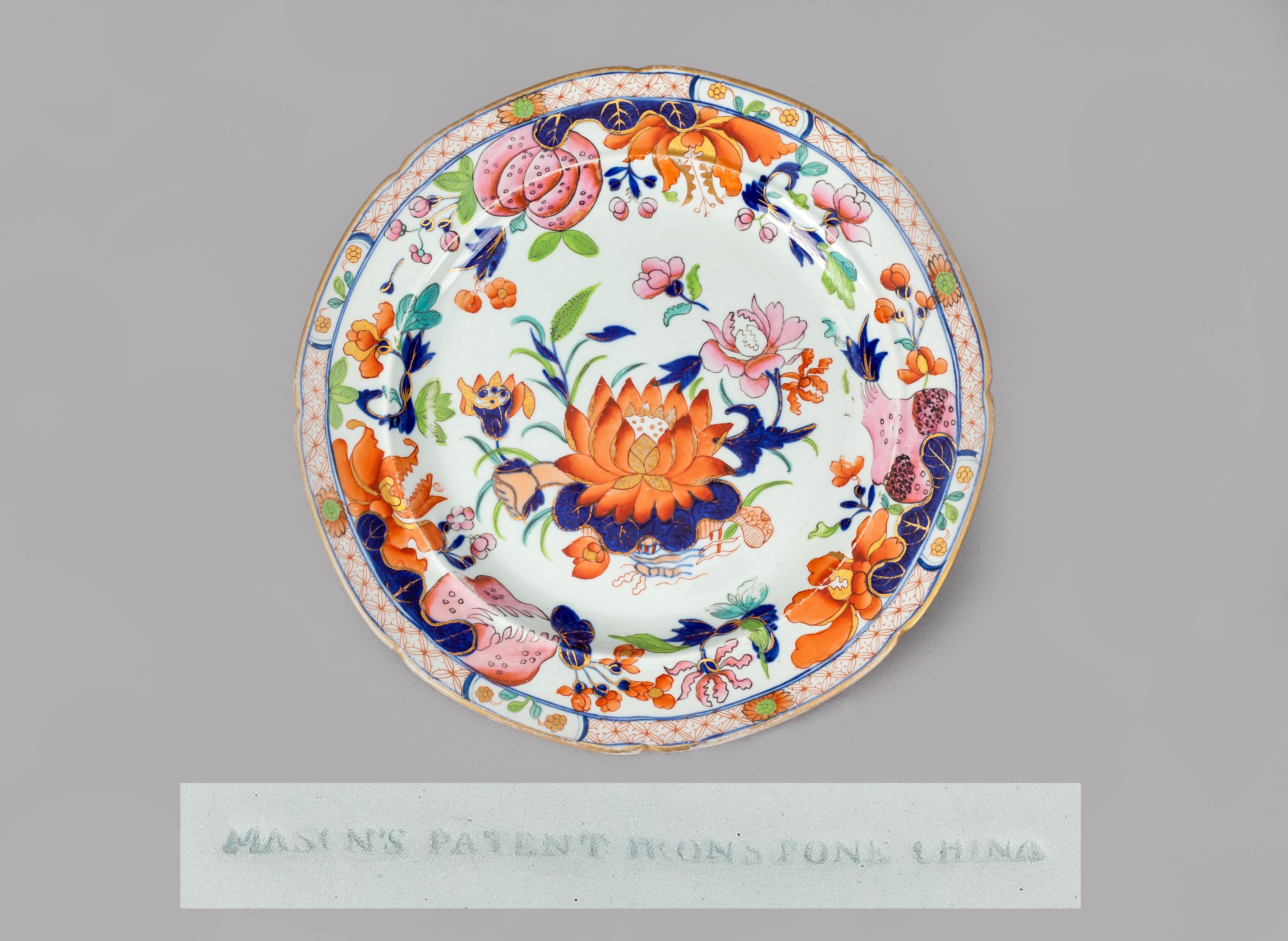 Part of a early 19th century Mason’s ironstone China dinner service in the Water Lily or Lotus pattern, decorated with the central theme of a large water lily surrounded by various flowers and foliage with a diaper border of red stylized flowers, in